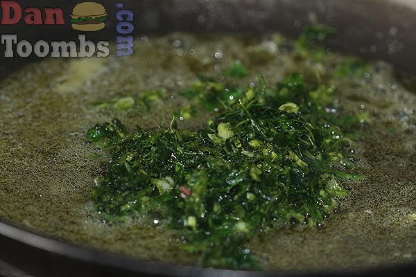 Frying garlic and parsley for the green bean recipe.