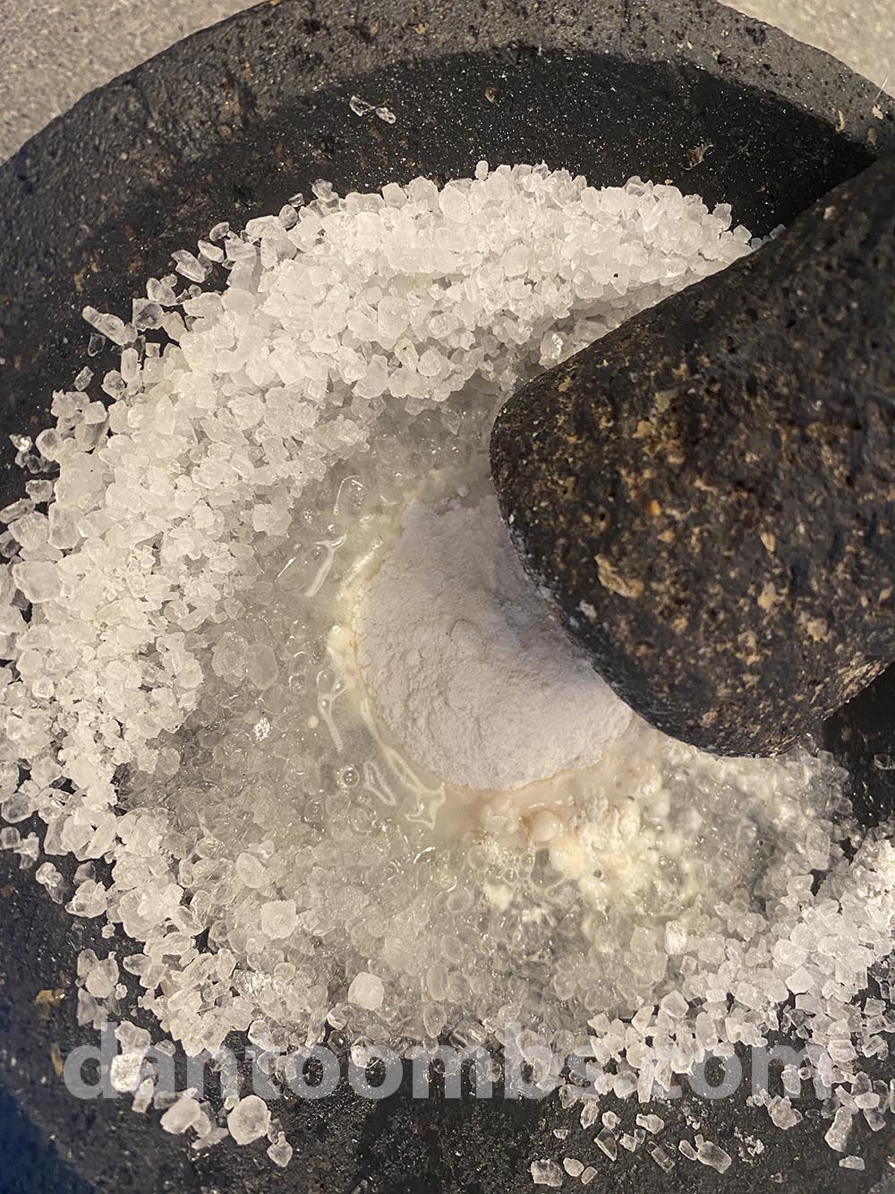 Pounding rock salt, flour and water