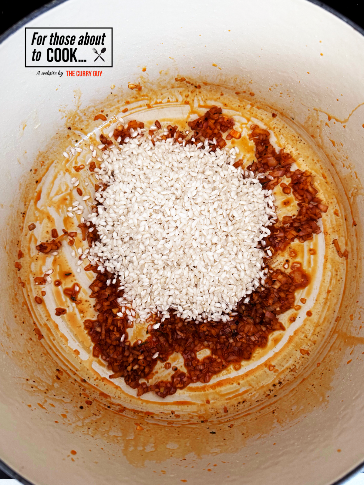 Arborio rice added to cooked onion and garlic in a pot