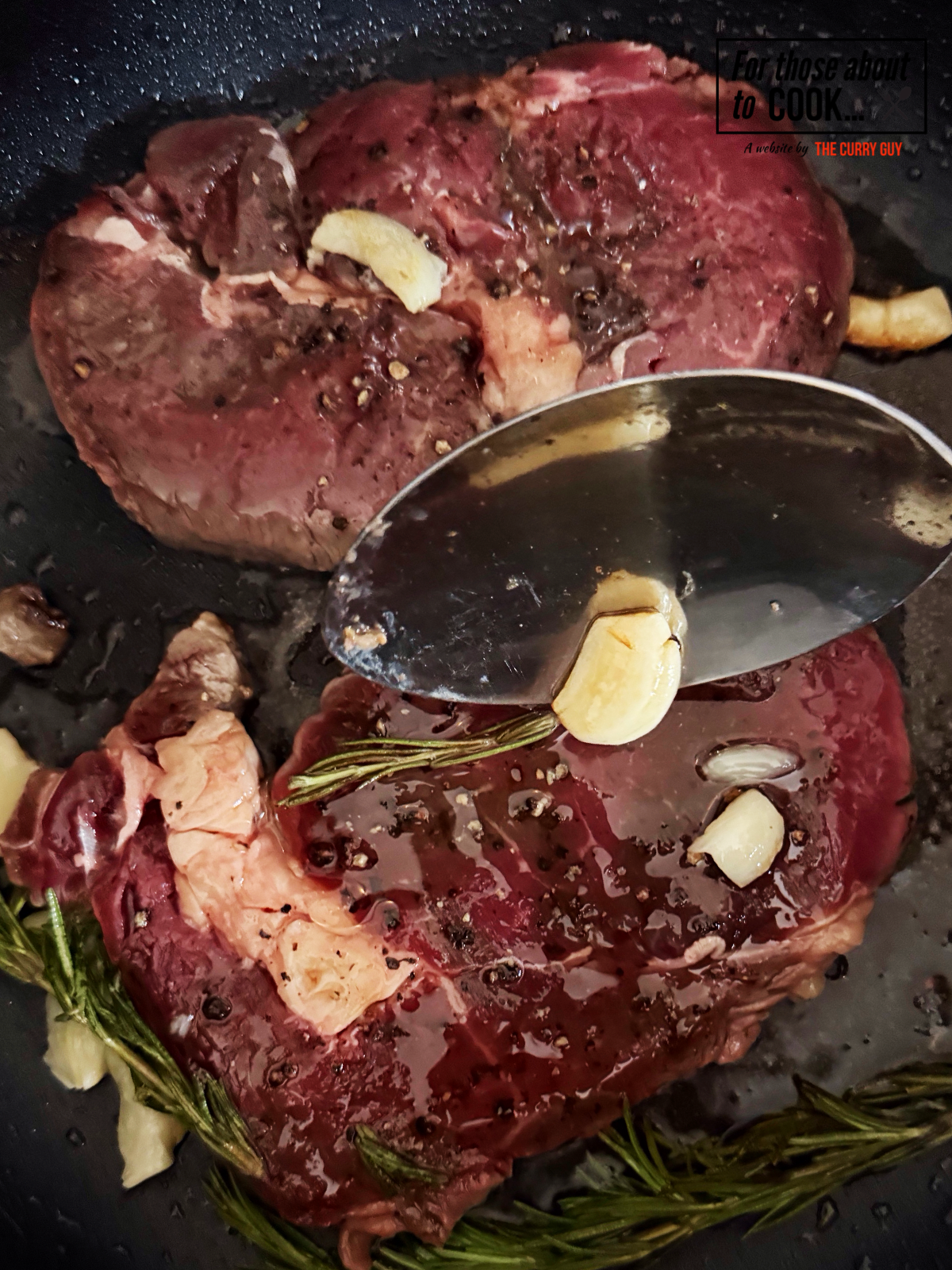 Ribeye steaks basted with garlic and rosemary oil