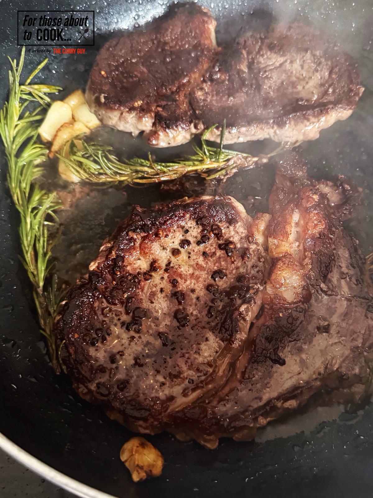 Ribeye steaks flipped in a pan