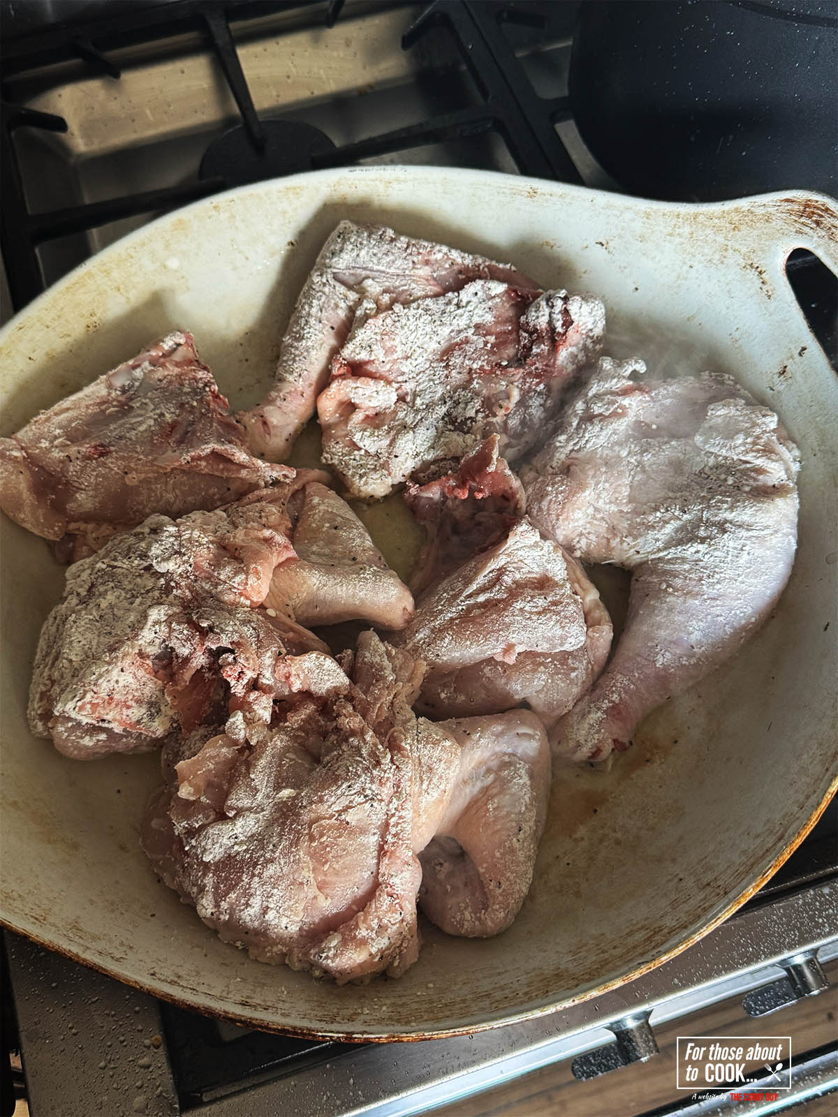 Frying the four dusted chicken in the olive oil.