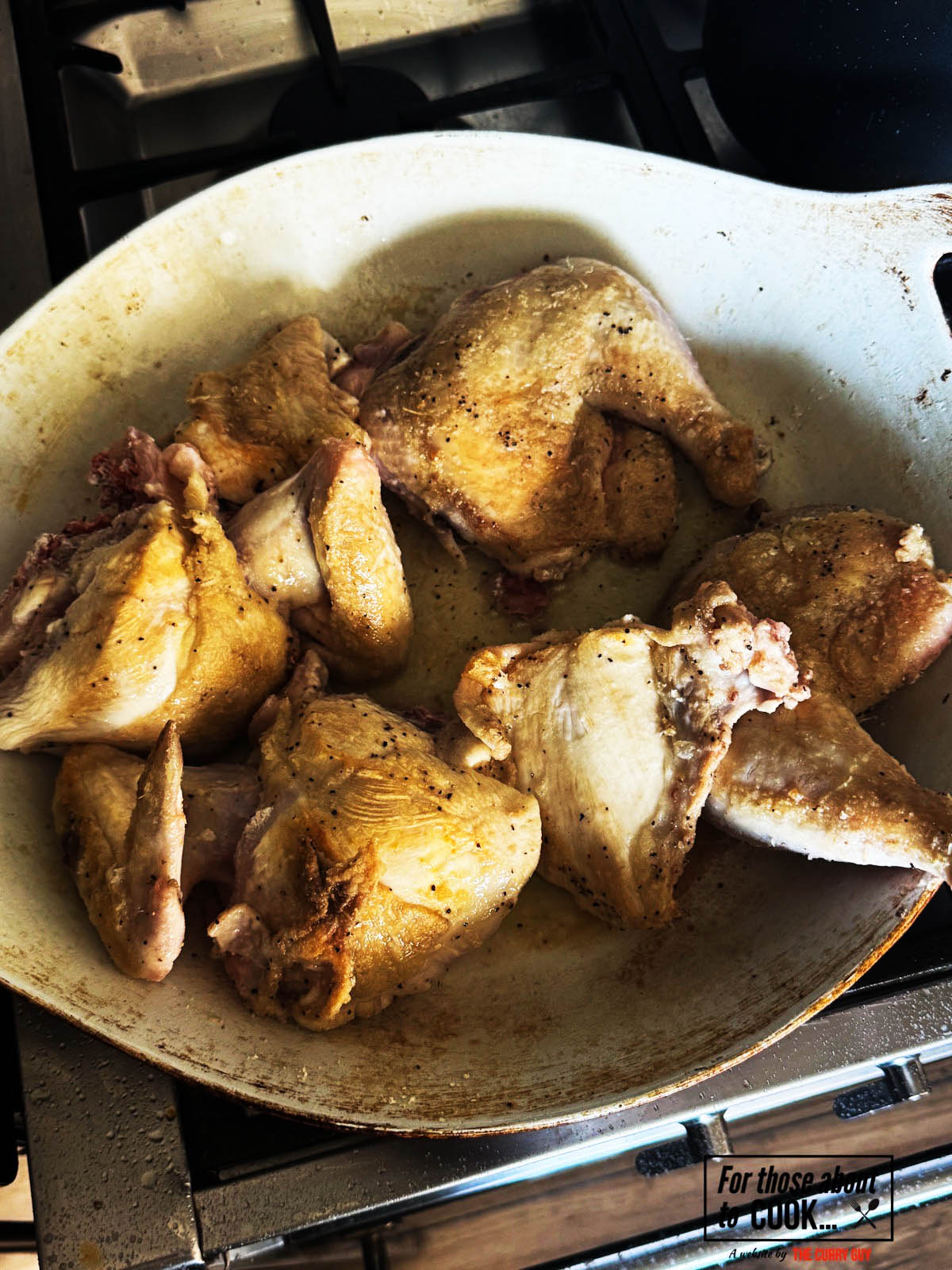 The browned chicken in the pan before transferring it to a plate to carry on with the recipe.
