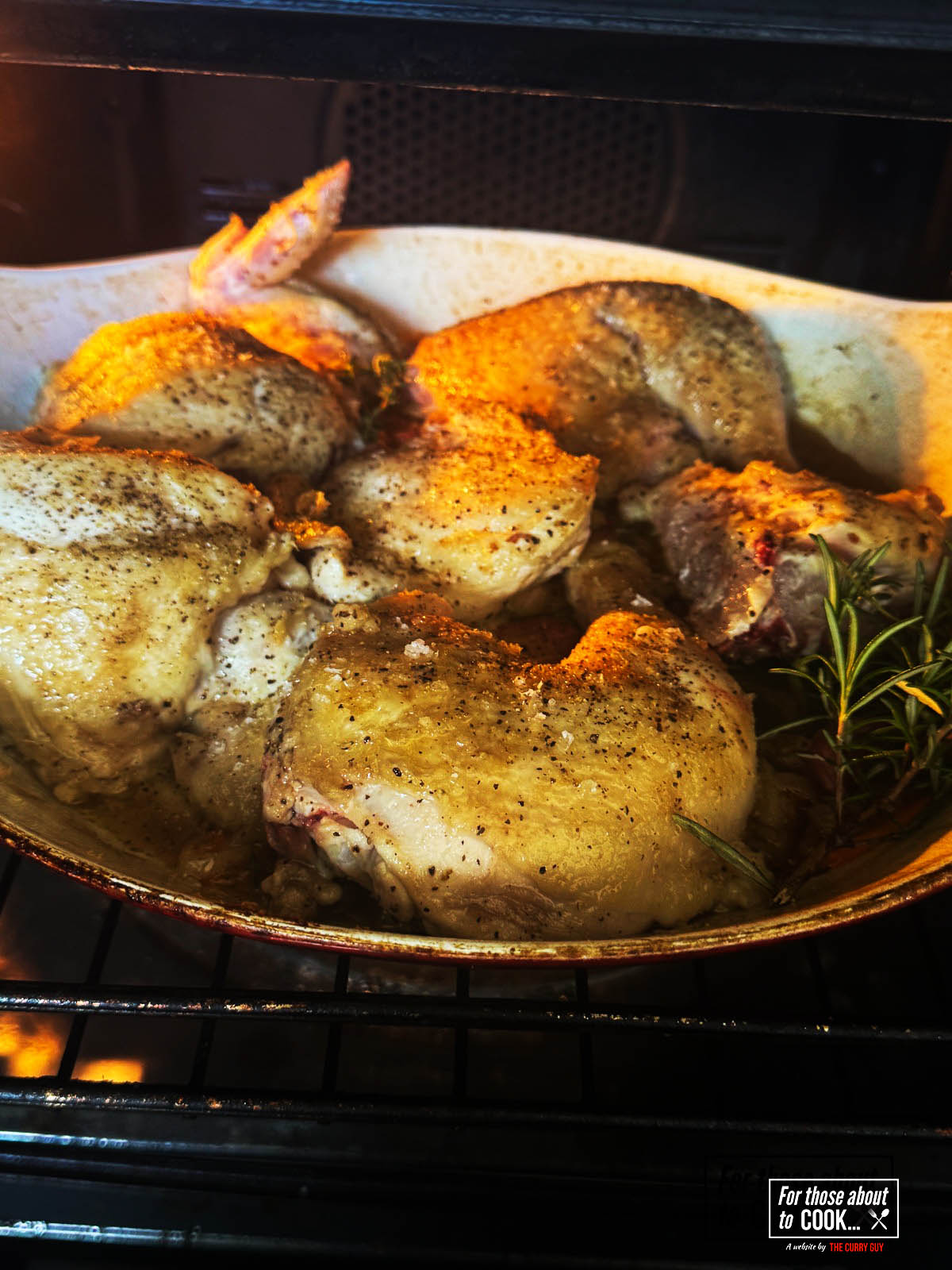 Roasting in the oven until the chicken is cooked through.