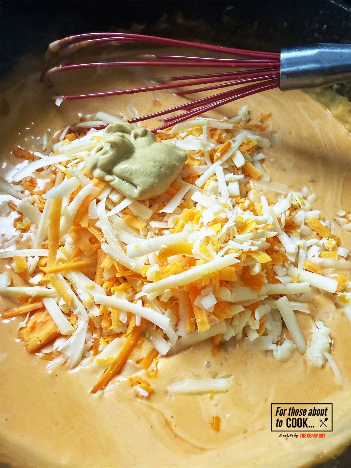 Adding cheese and mustard