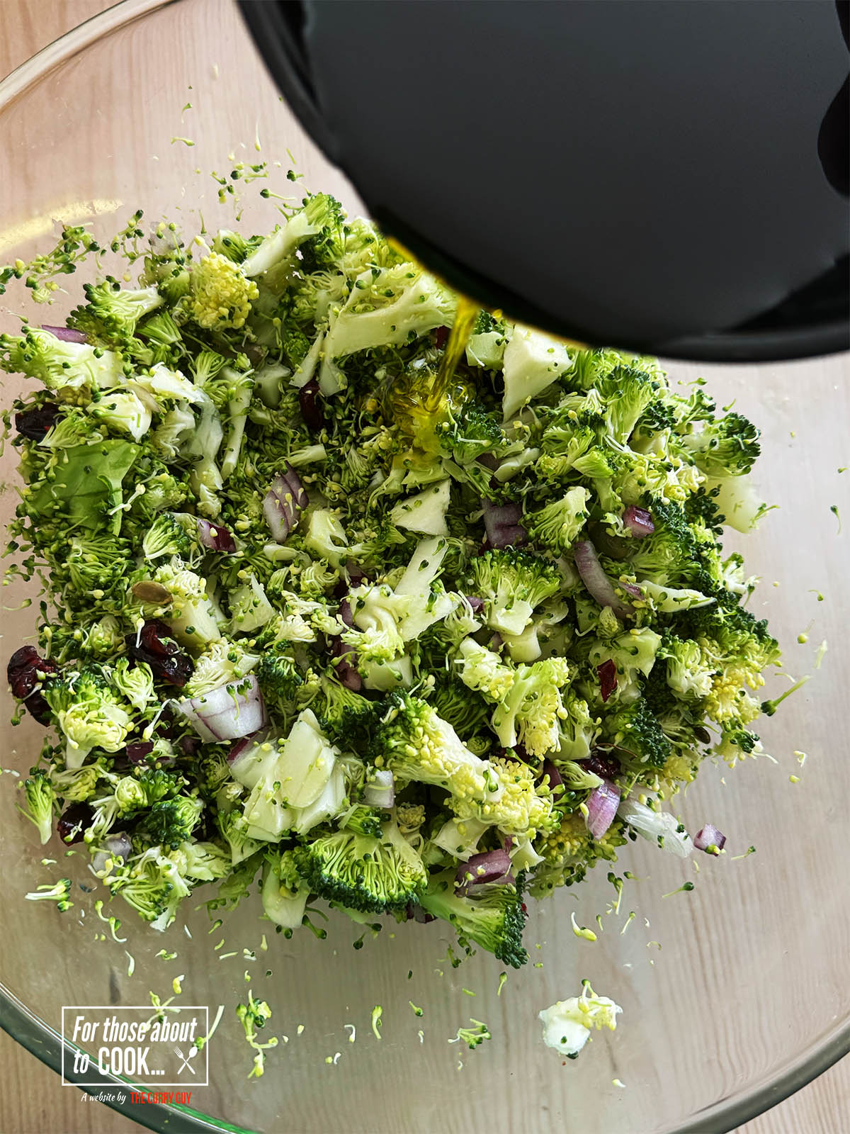 Pouring in the olive oil and mixing it in.