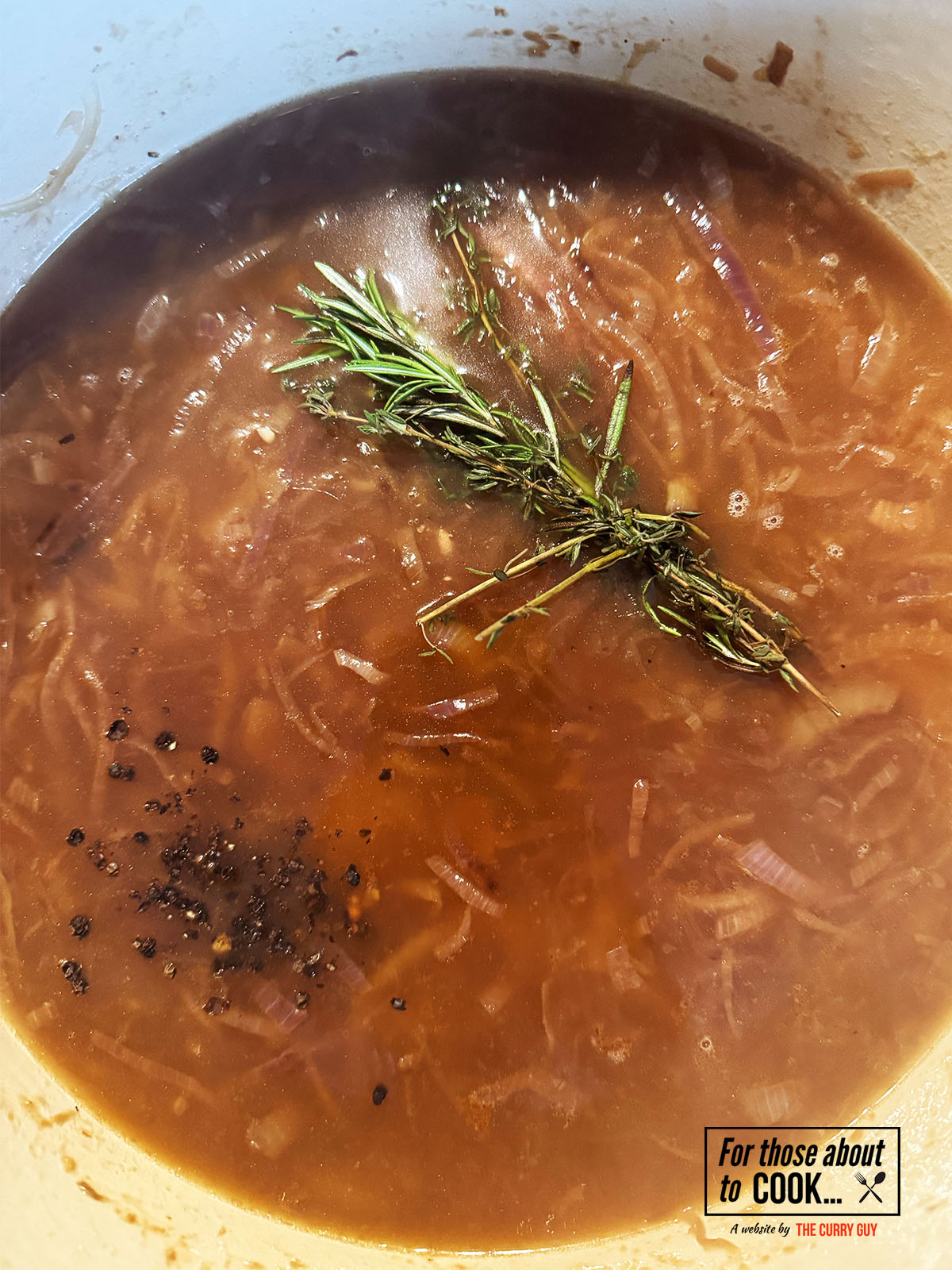 Beef stock and tied herbs added to the pot