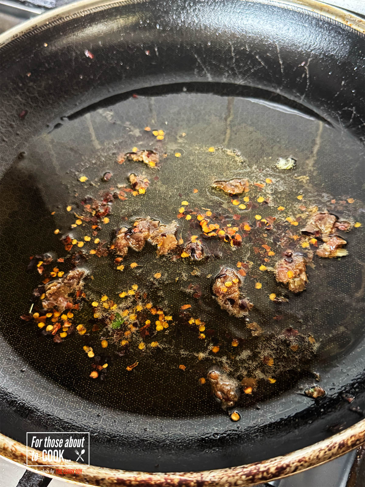 Frying the anchovies and chili flakes in olive oil over a medium heat.