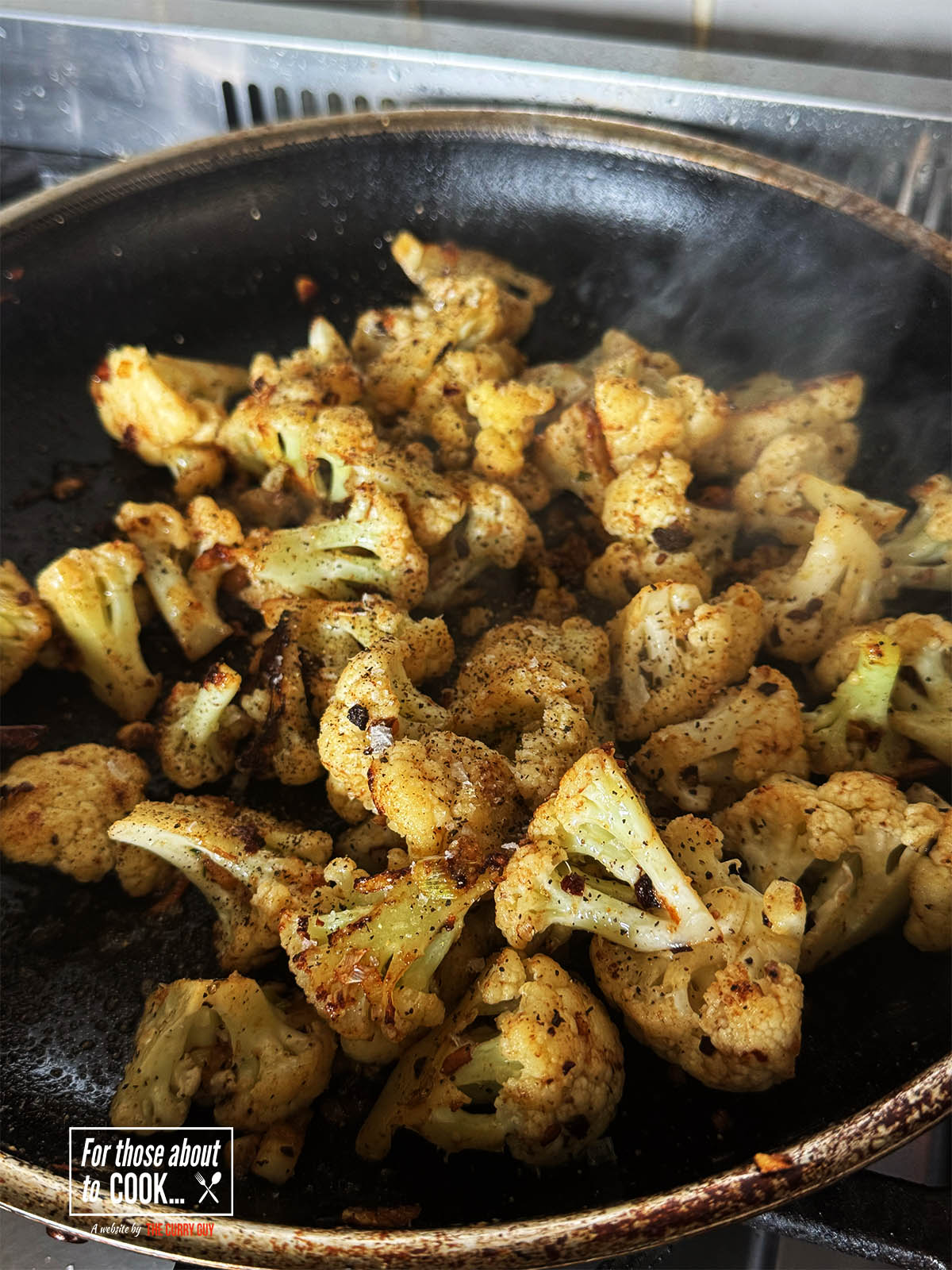 Browning the cauliflower in the pan.