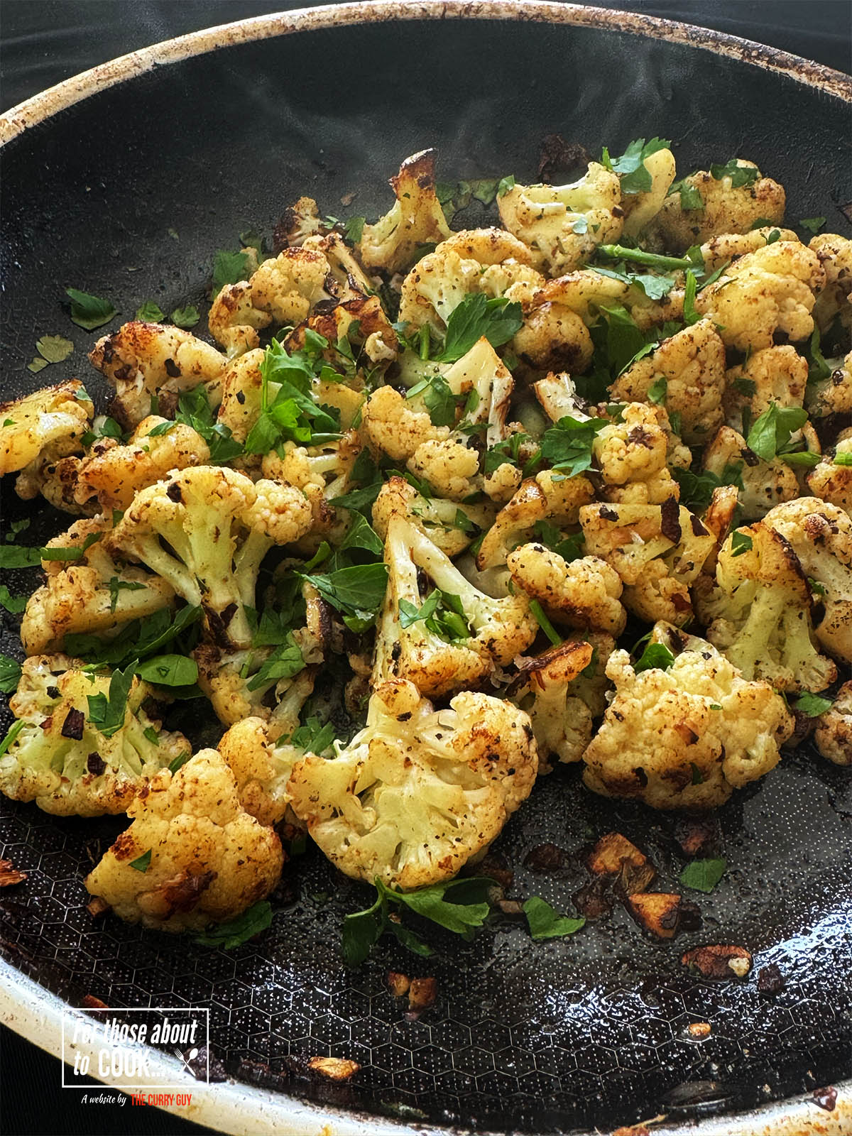 Italian fried cauliflower with Anchovies and garlic in a frying pan.
