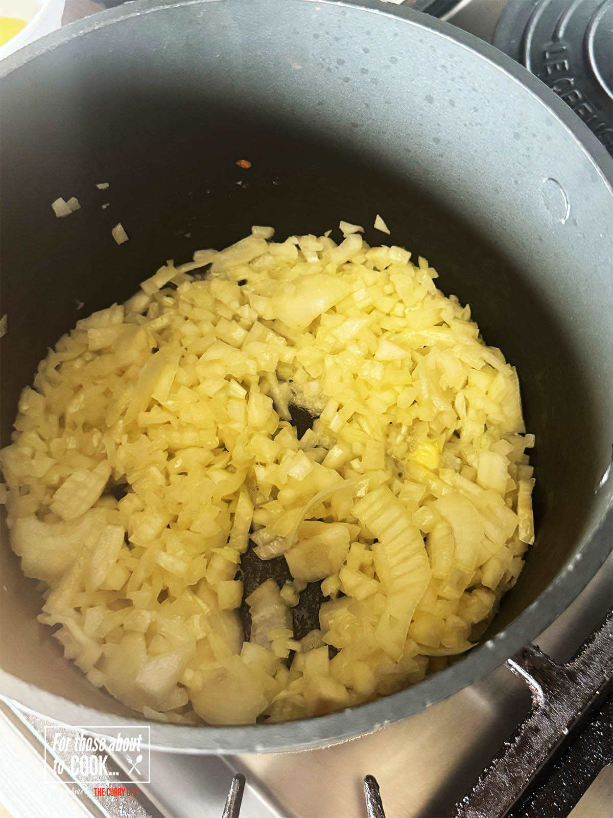 Frying the chopped onions in butter and olive oil in a pan over medium heat.