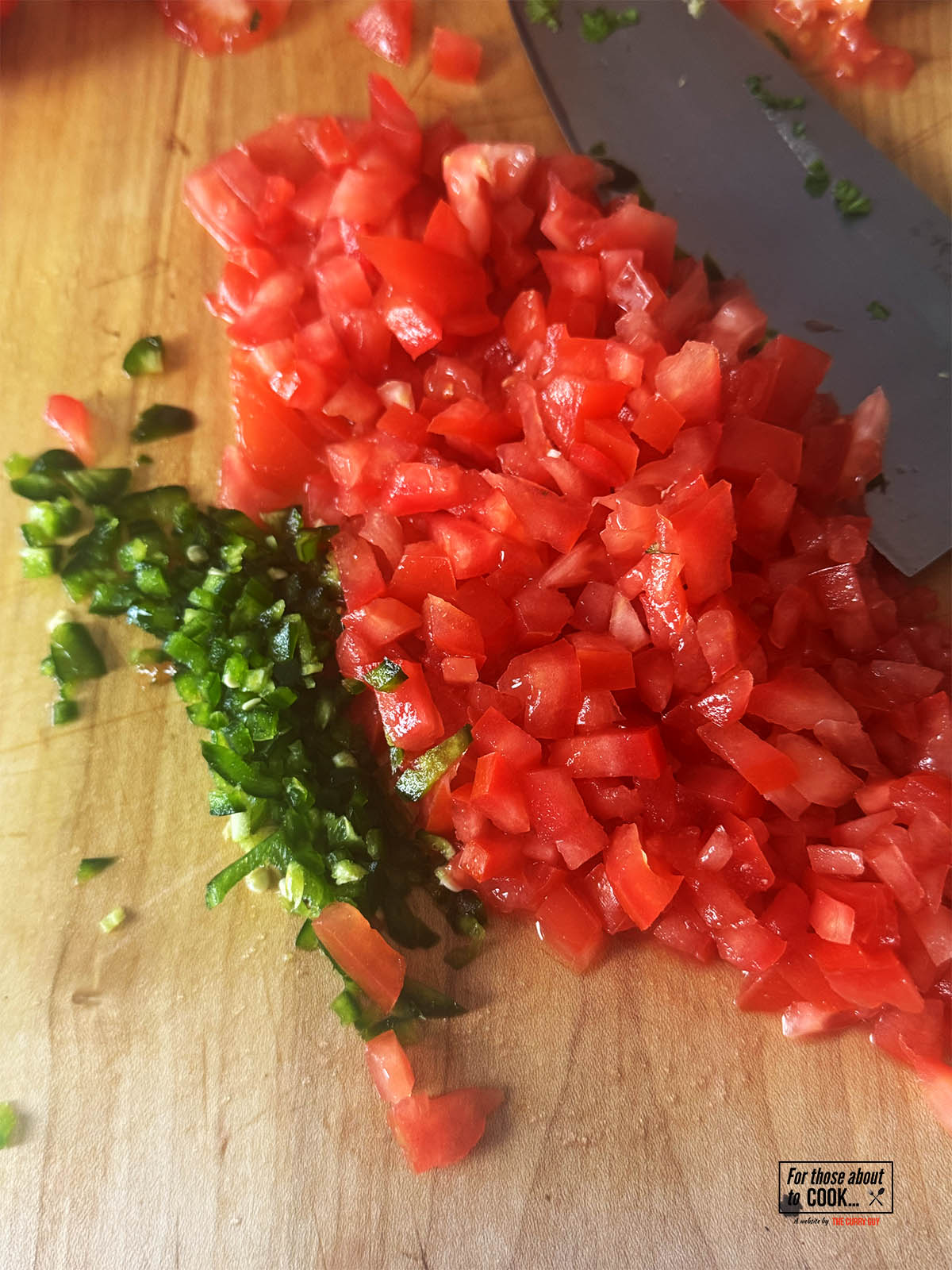 Dicing the tomatoes and chilies.