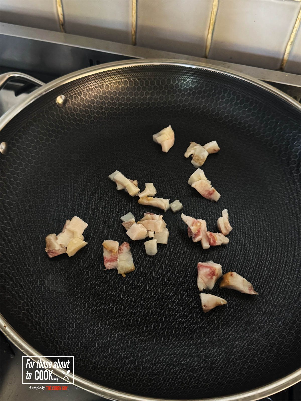 Frying the guanciale until it becomes crisp and browned.