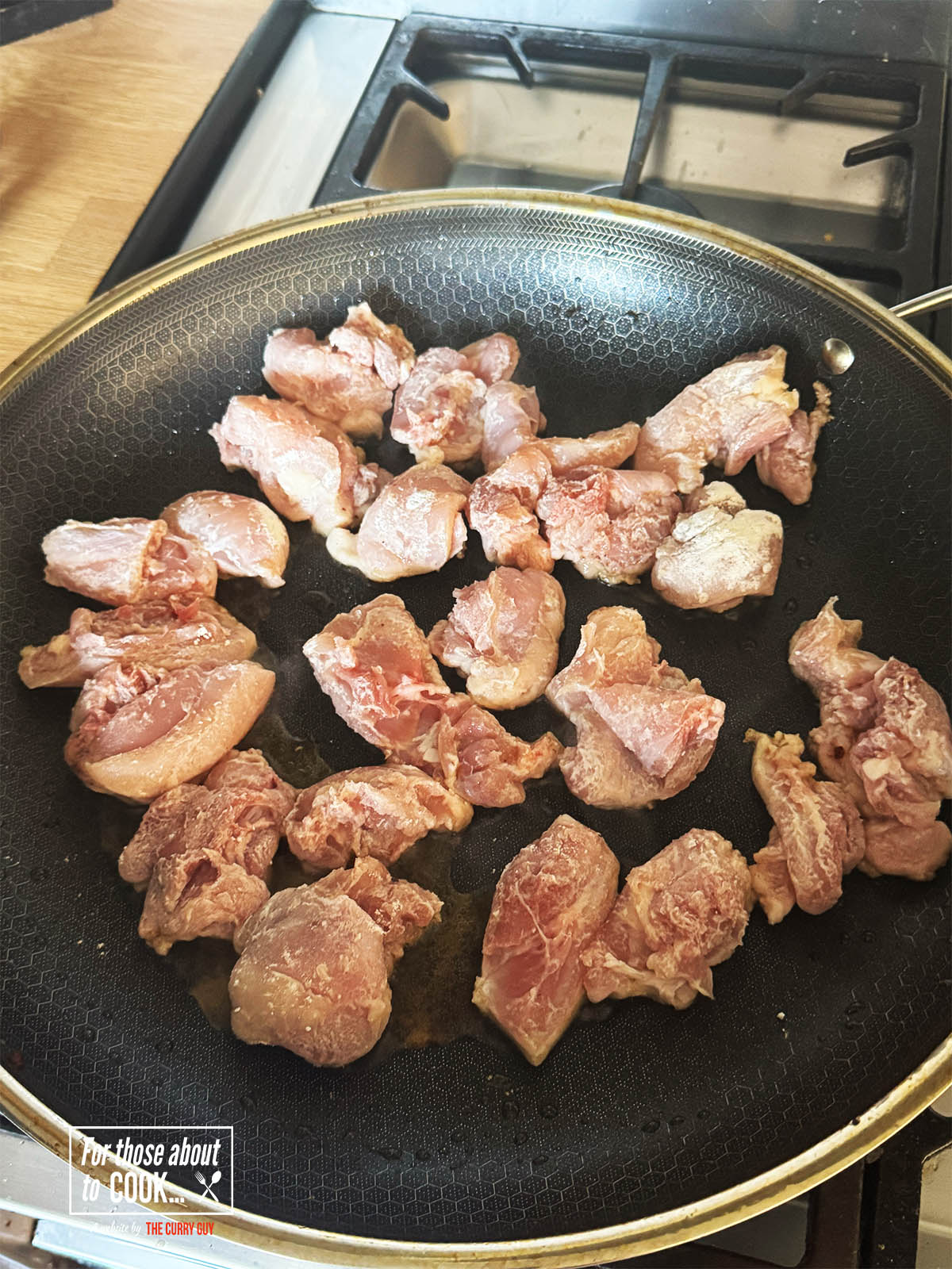 Adding the flour dusted chicken to the pan.