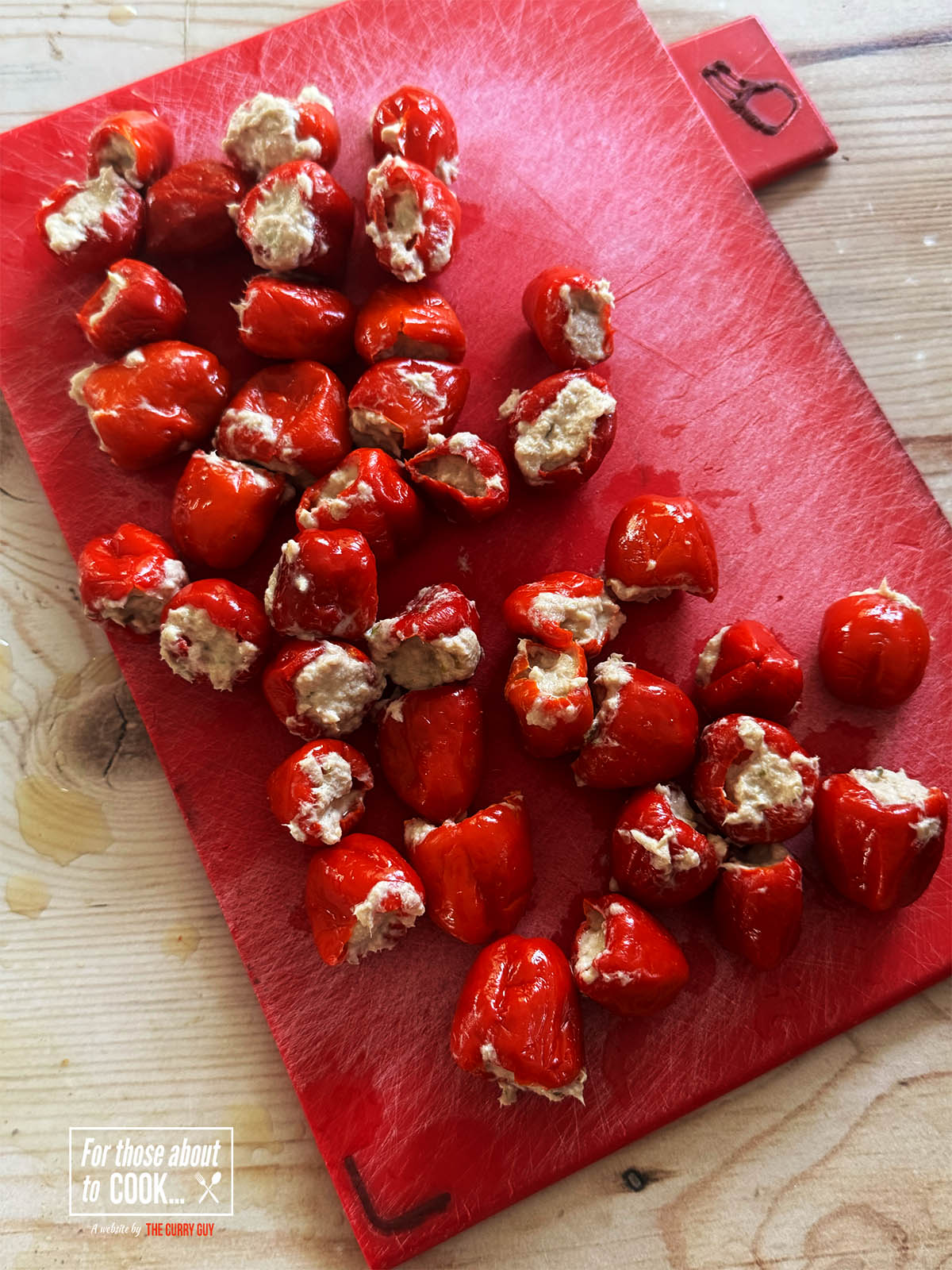 The peppers filled with the tuna mixture on a work surface.