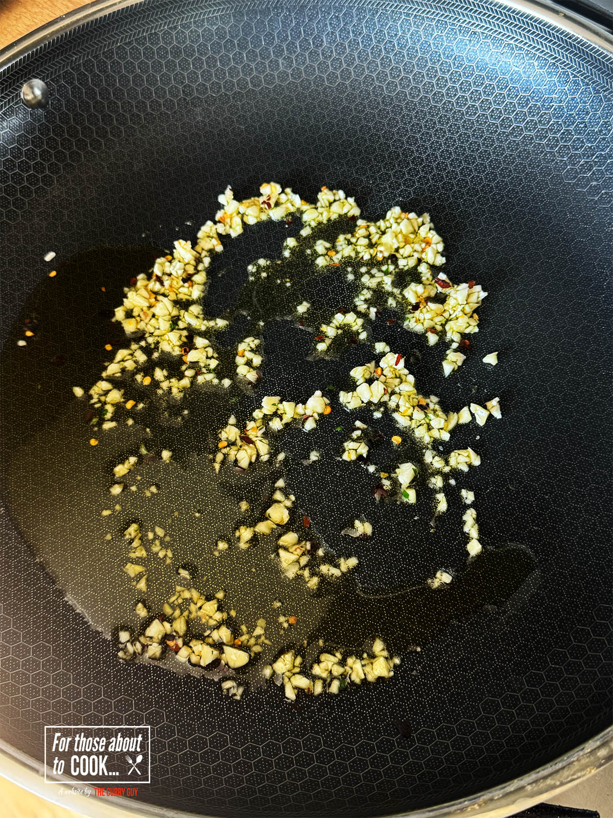 Frying the garlic and dried chilies in olive oil.