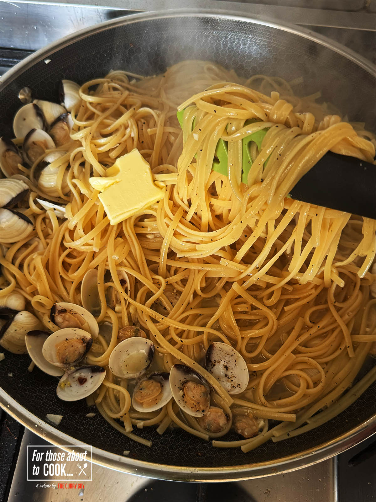 Tossing the pasta into the sauce.