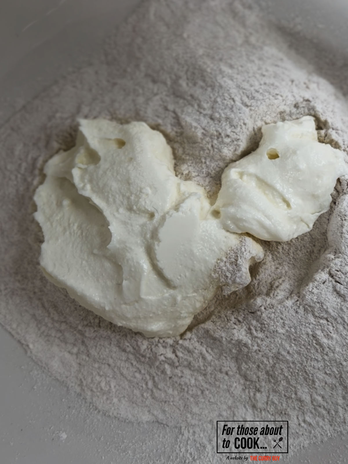 Greek yoghurt and self raising flour in a bowl