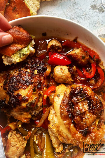 Finished Italian chicken in a bowl with garlic bread