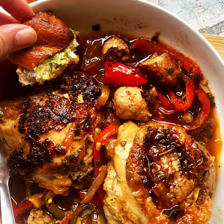 Finished Italian chicken in a bowl with garlic bread