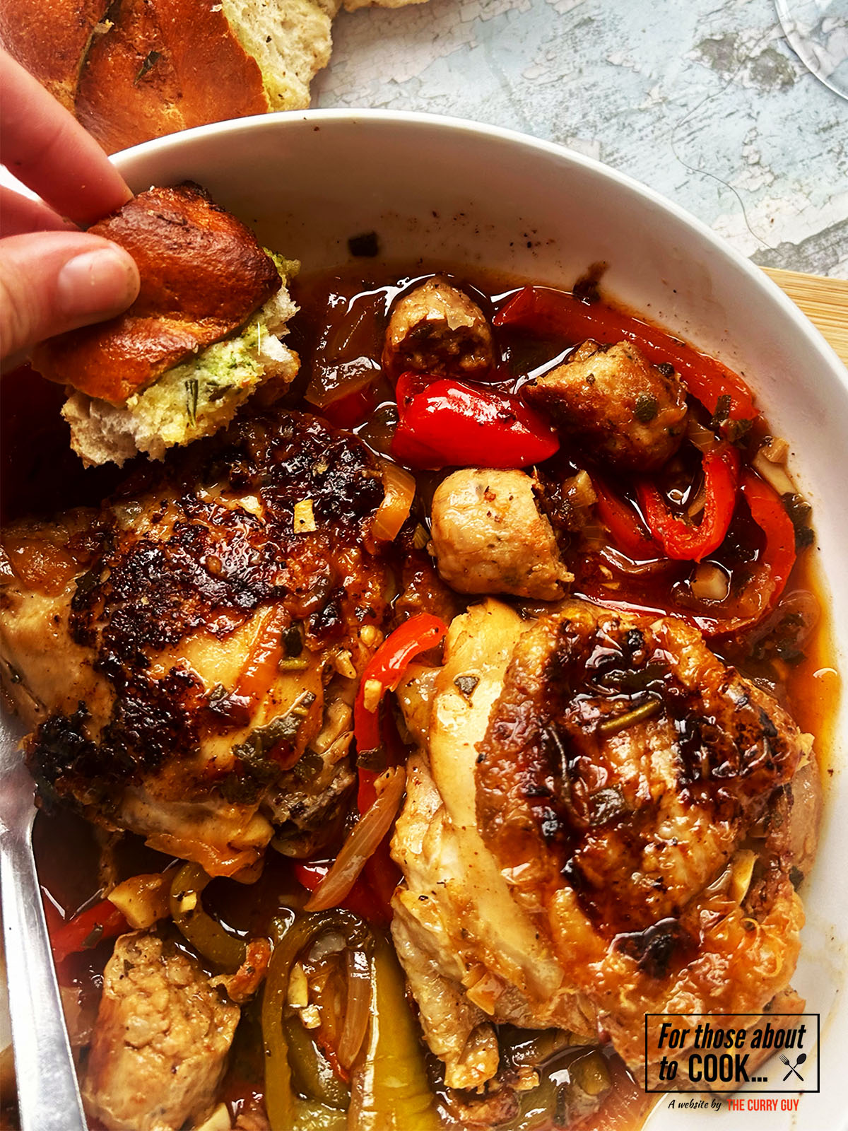 Finished Italian chicken in a bowl with garlic bread