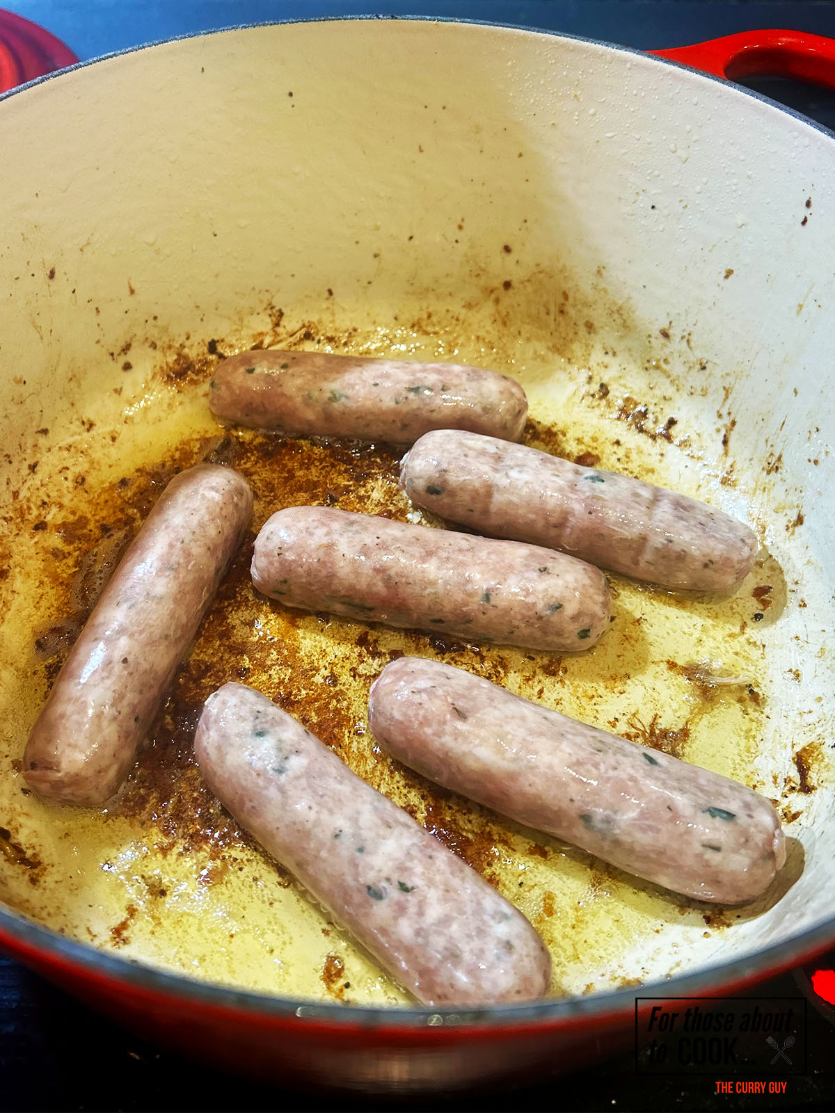 Sausages frying in a pan
