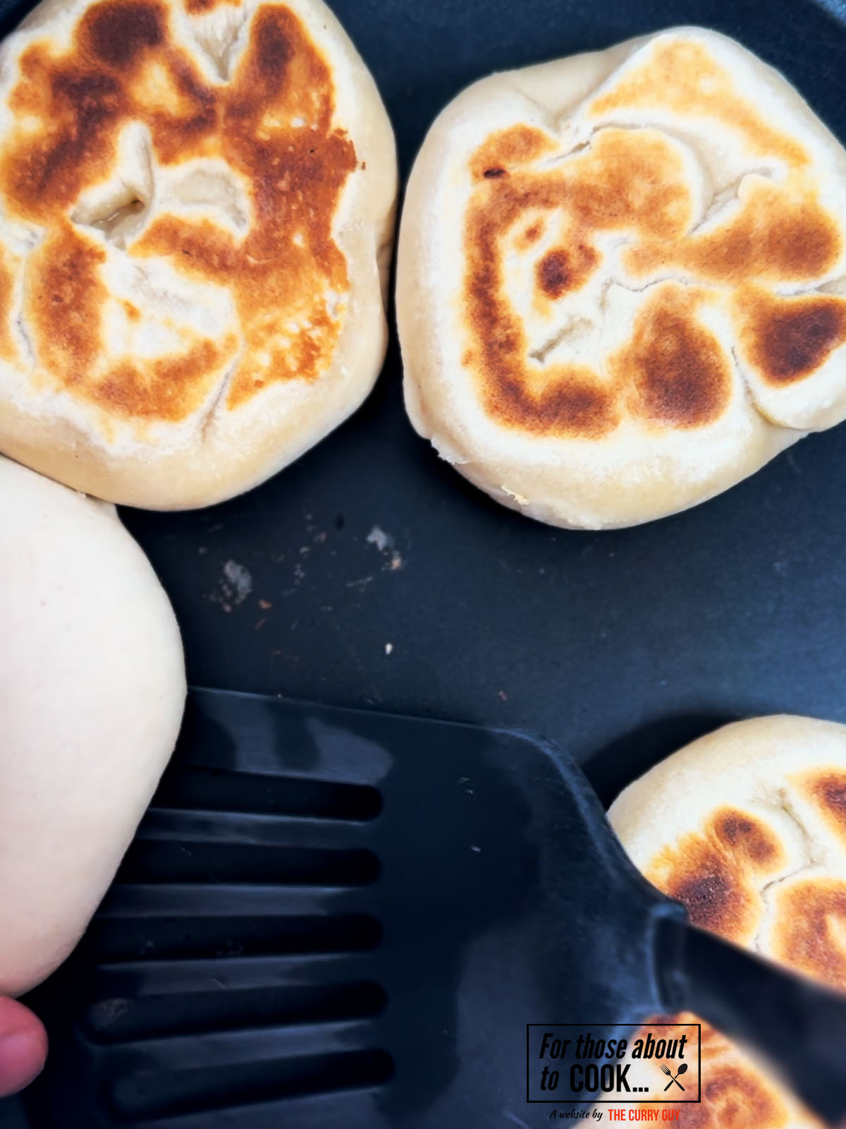 Flatbreads grilling in a pan