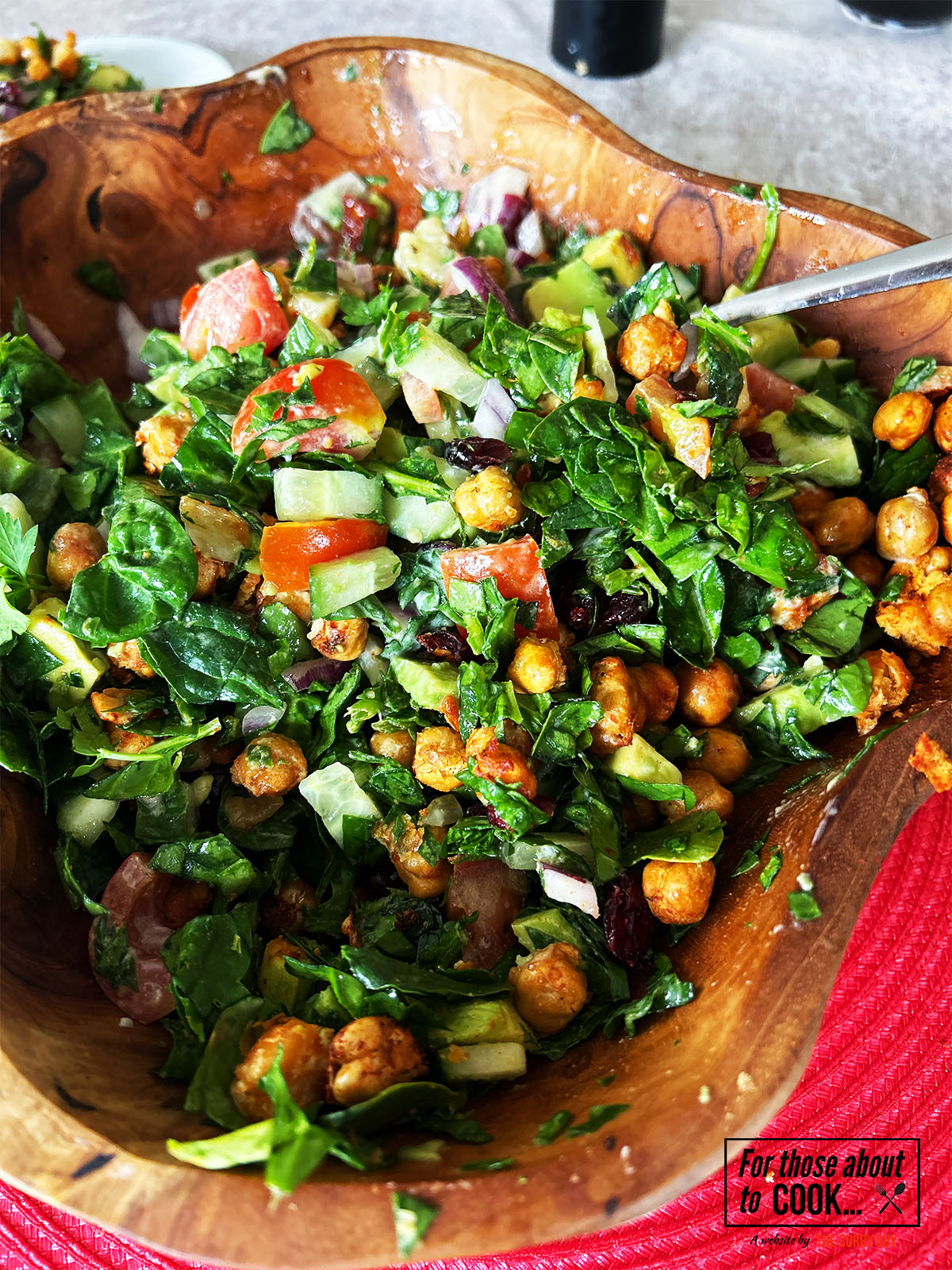 Tossed chickpeas, halloumi and dressing in a bowl 