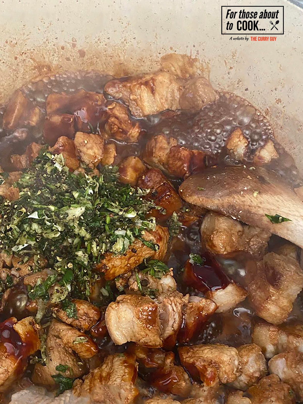 thai pork belly stew in a pan cooking