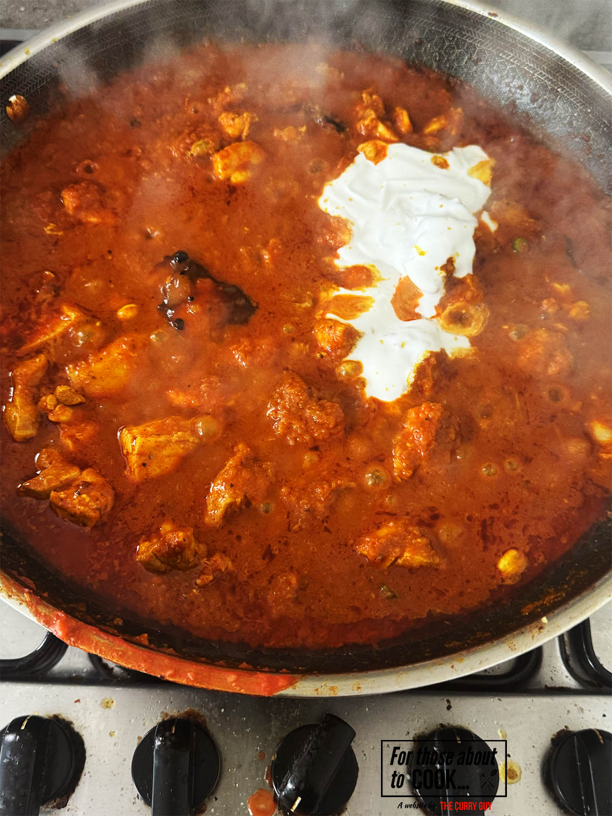 Adding the coconut milk and mango chutney to the sauce.