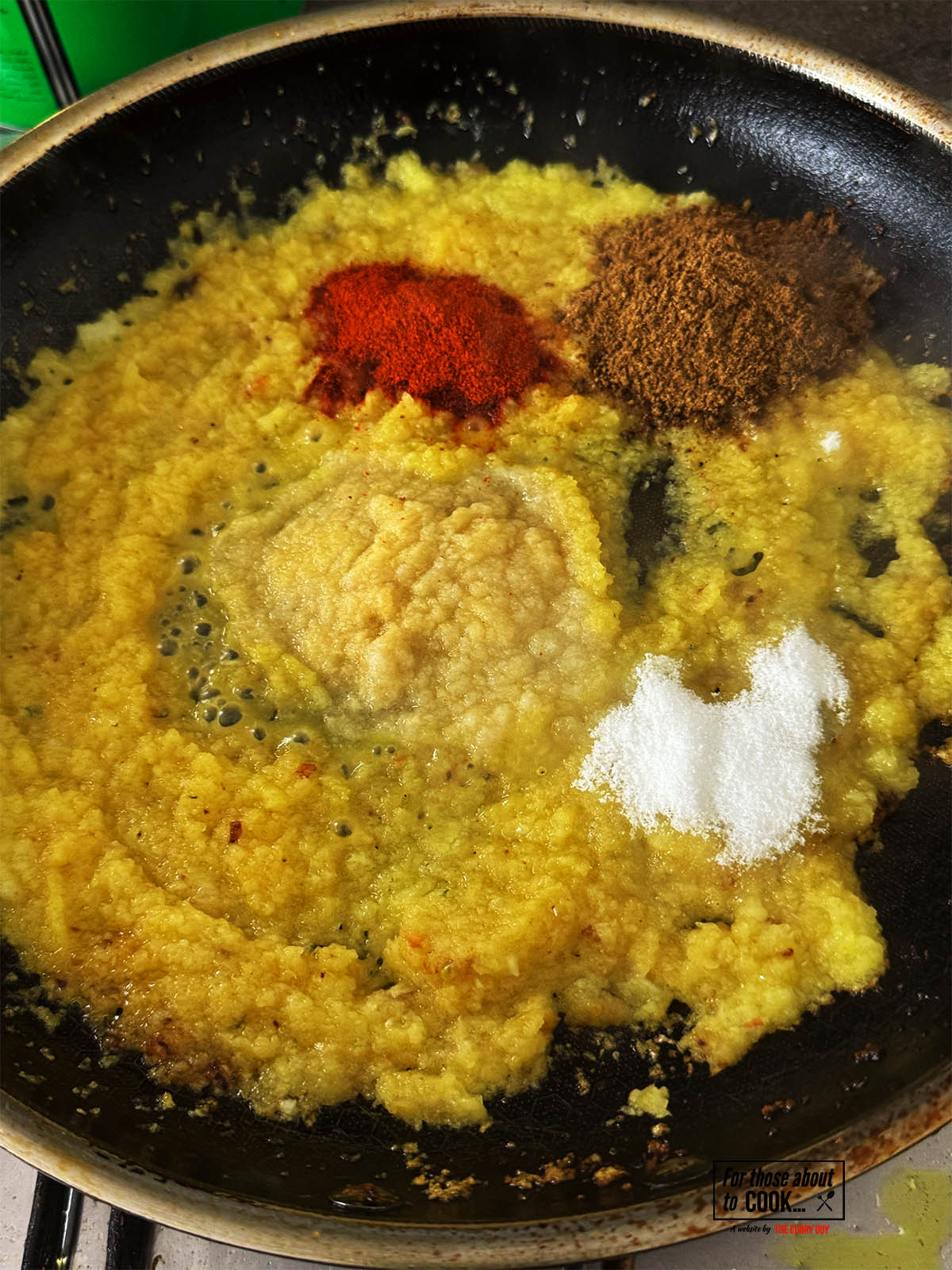 Adding the garlic and ginger paste to fry for 30 seconds and the stirring in the chilli powder, garam masala and sugar.