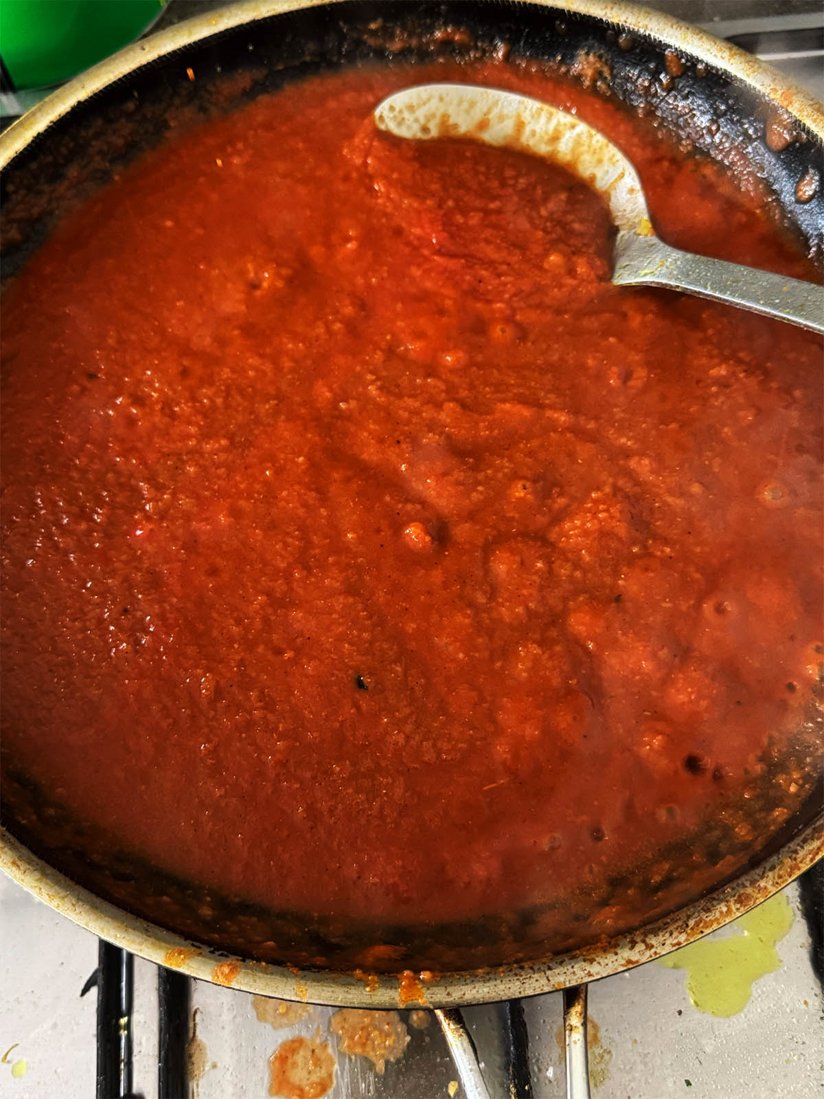 The chicken stock and passata in the pan.