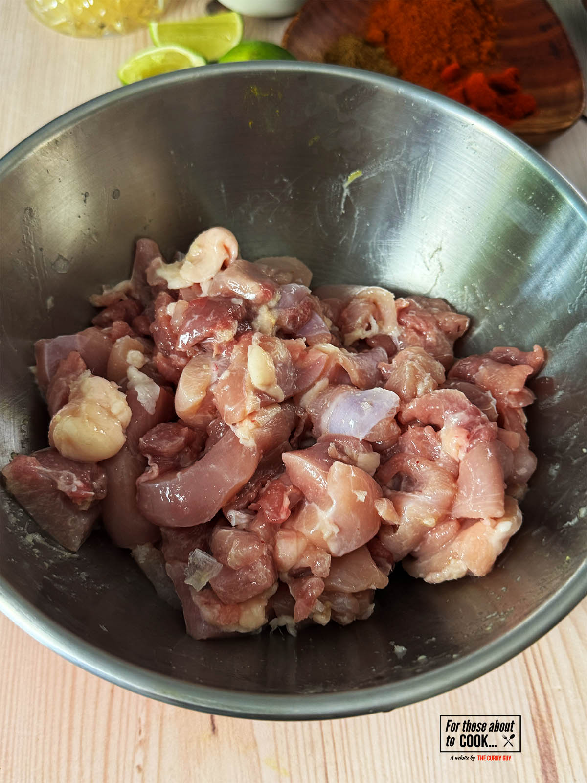 The chicken marinating in a bowl.