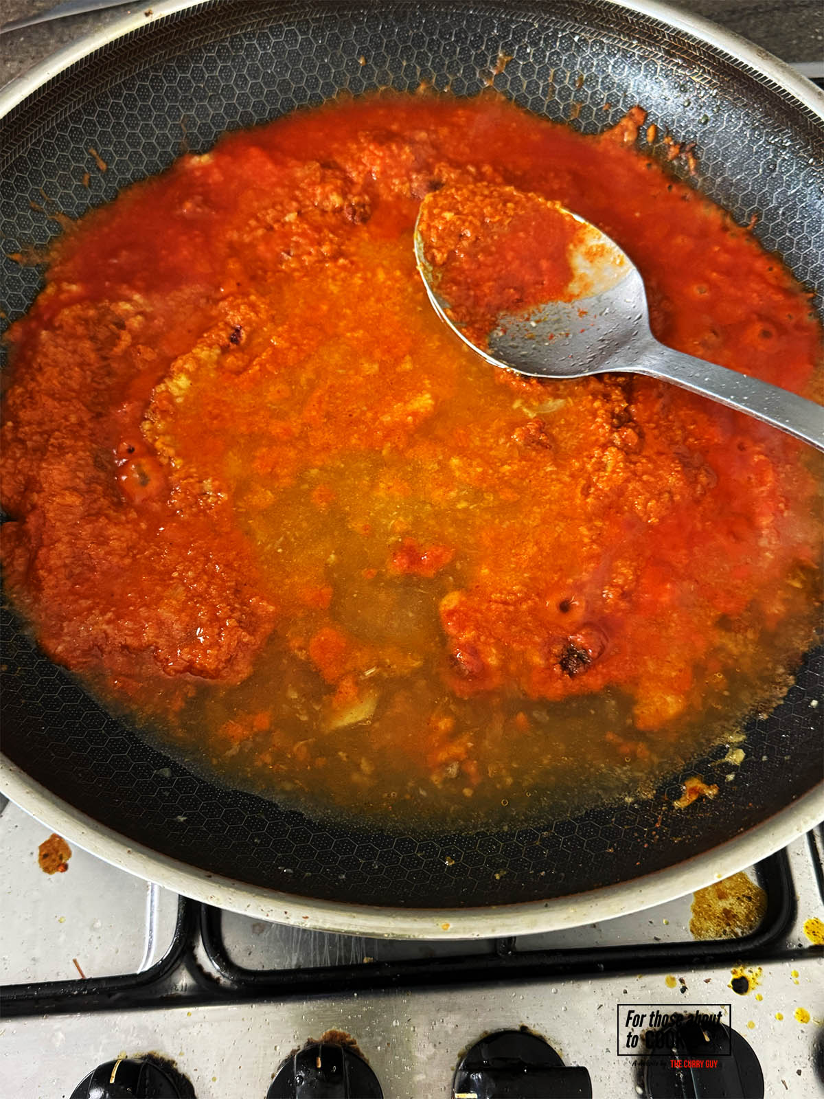 Adding the passata and stock to the pan.