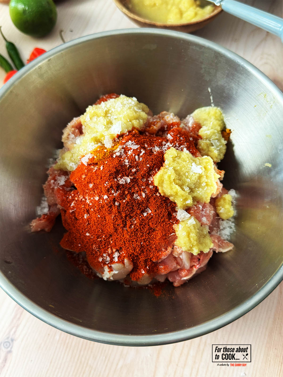 Mixing the chicken with the marinade ingredients in a bowl.