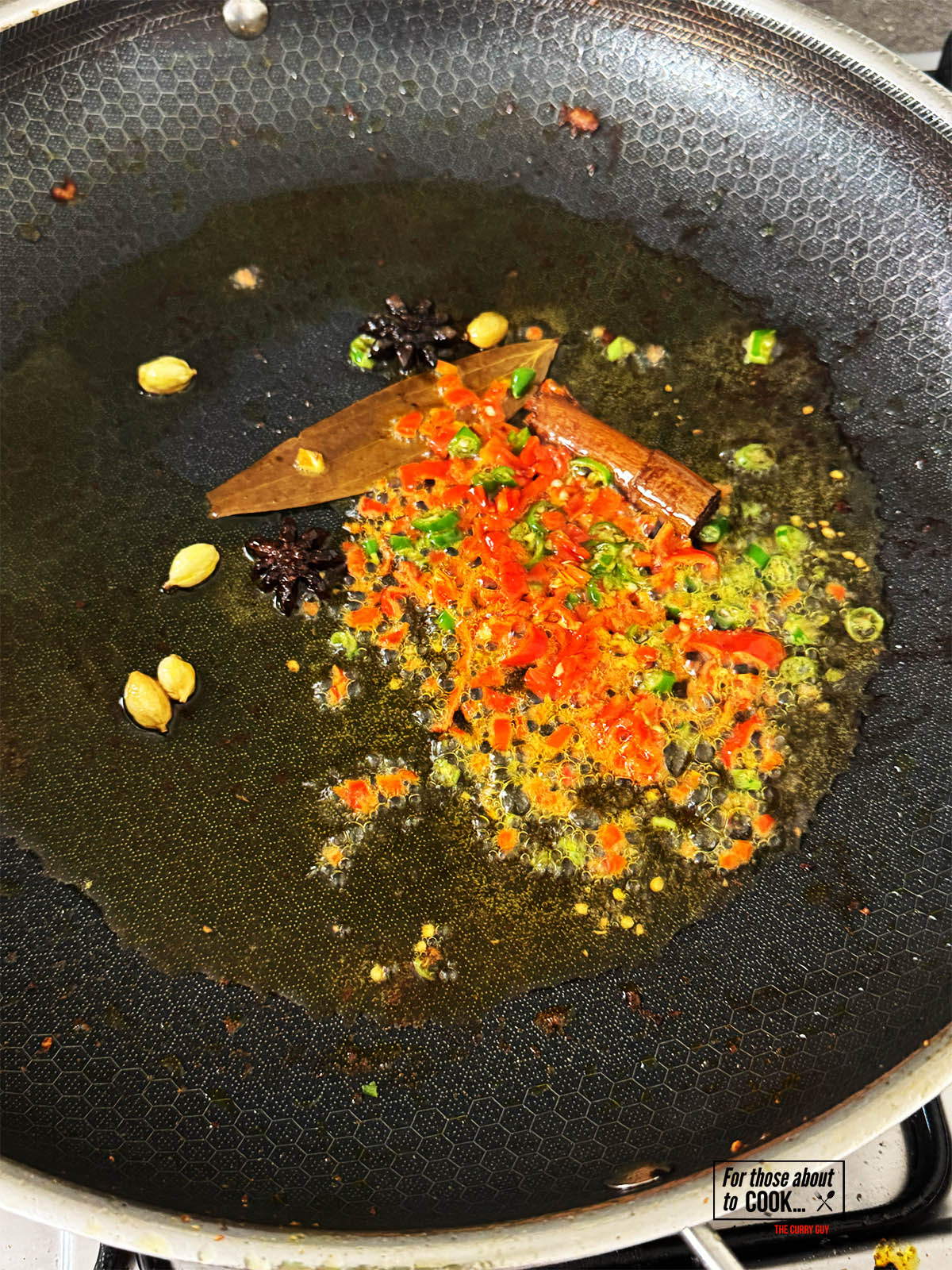 Stirring the chopped chillies into the hot ghee.