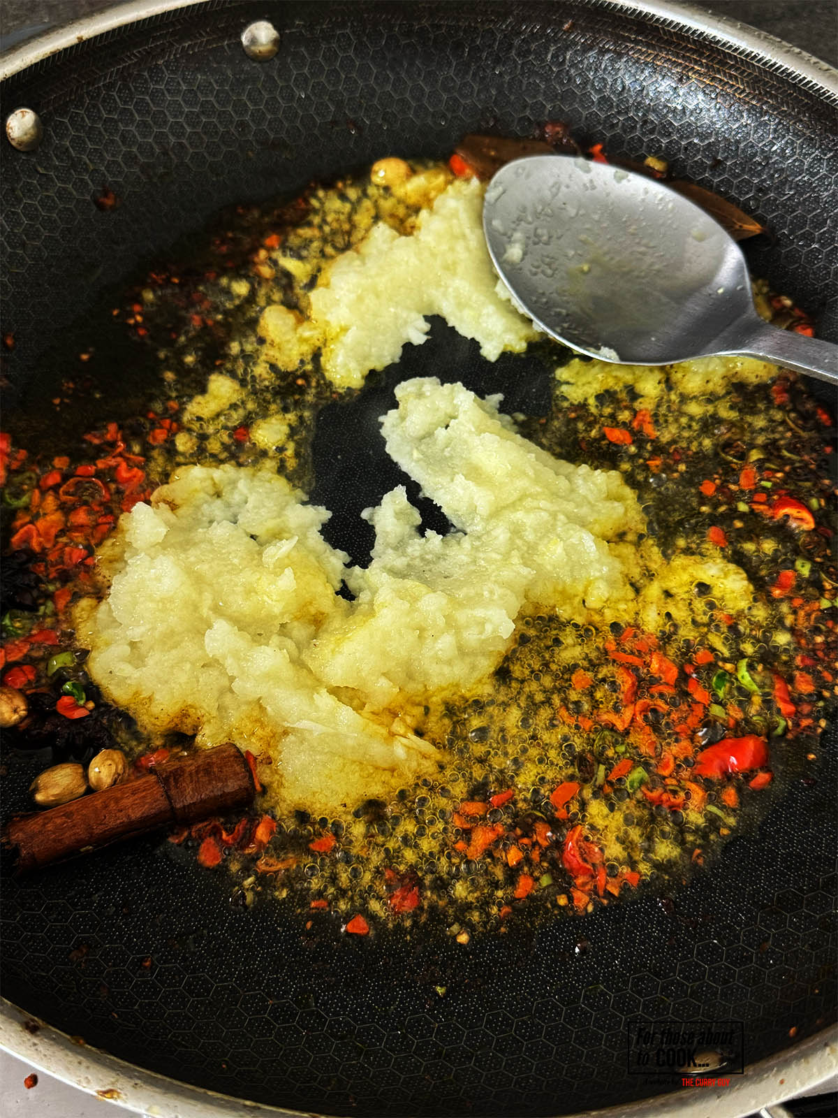 Adding the blended onions to the pan.