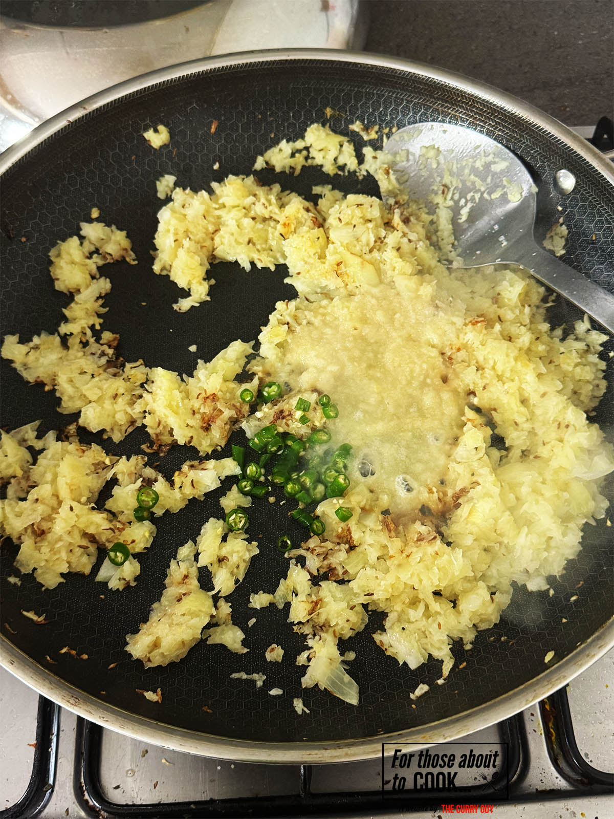 Adding the garlic and ginger paste and chopped chillies to the pan.