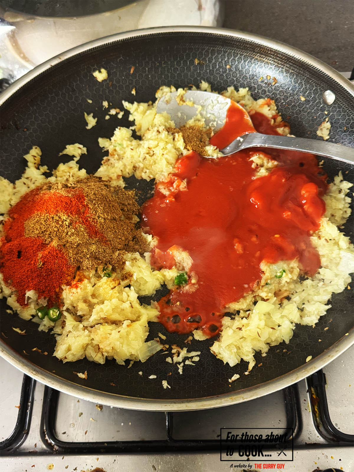 Adding the ground spices and passata to the pan