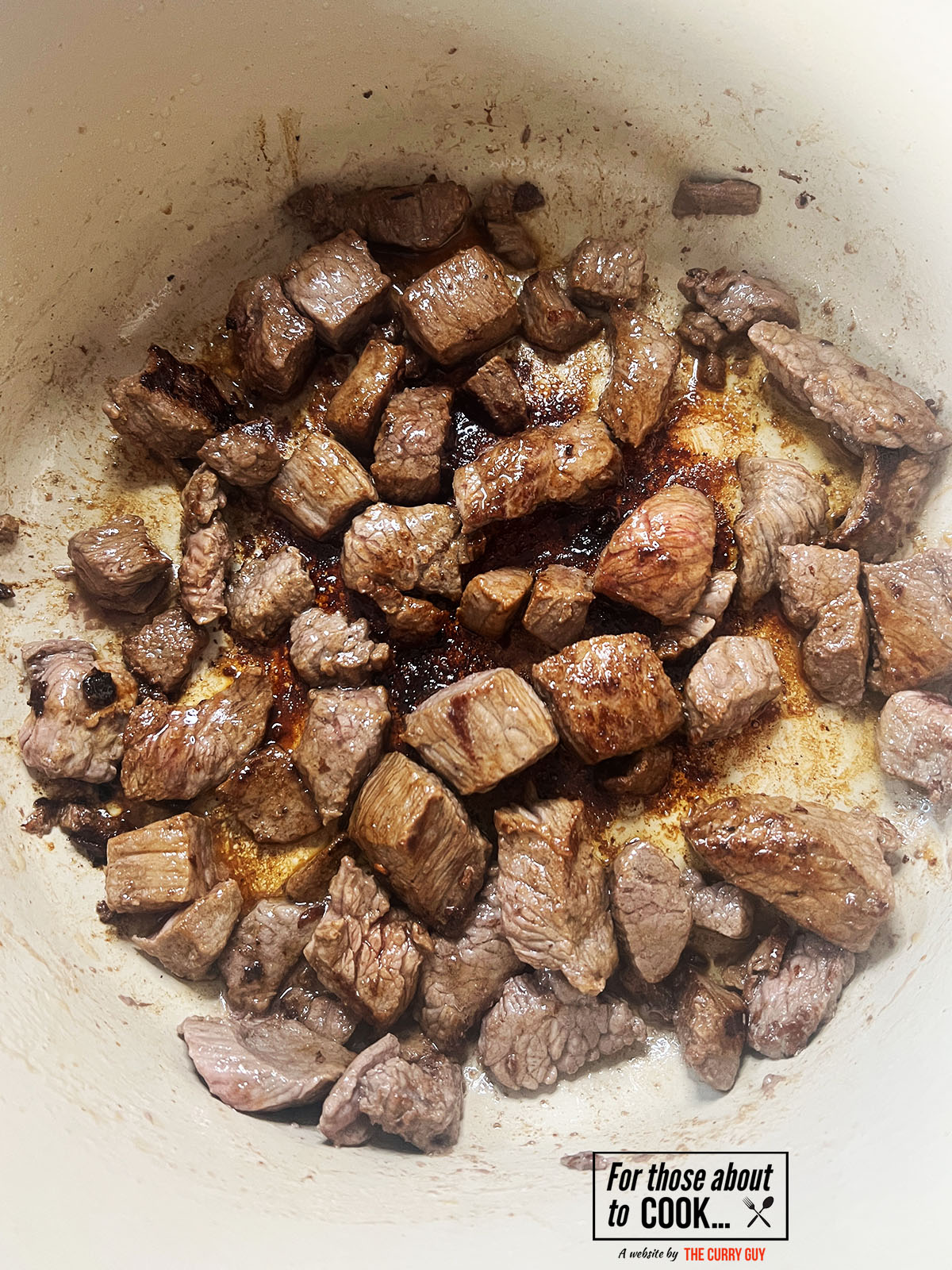Beef chunks browning in a pan