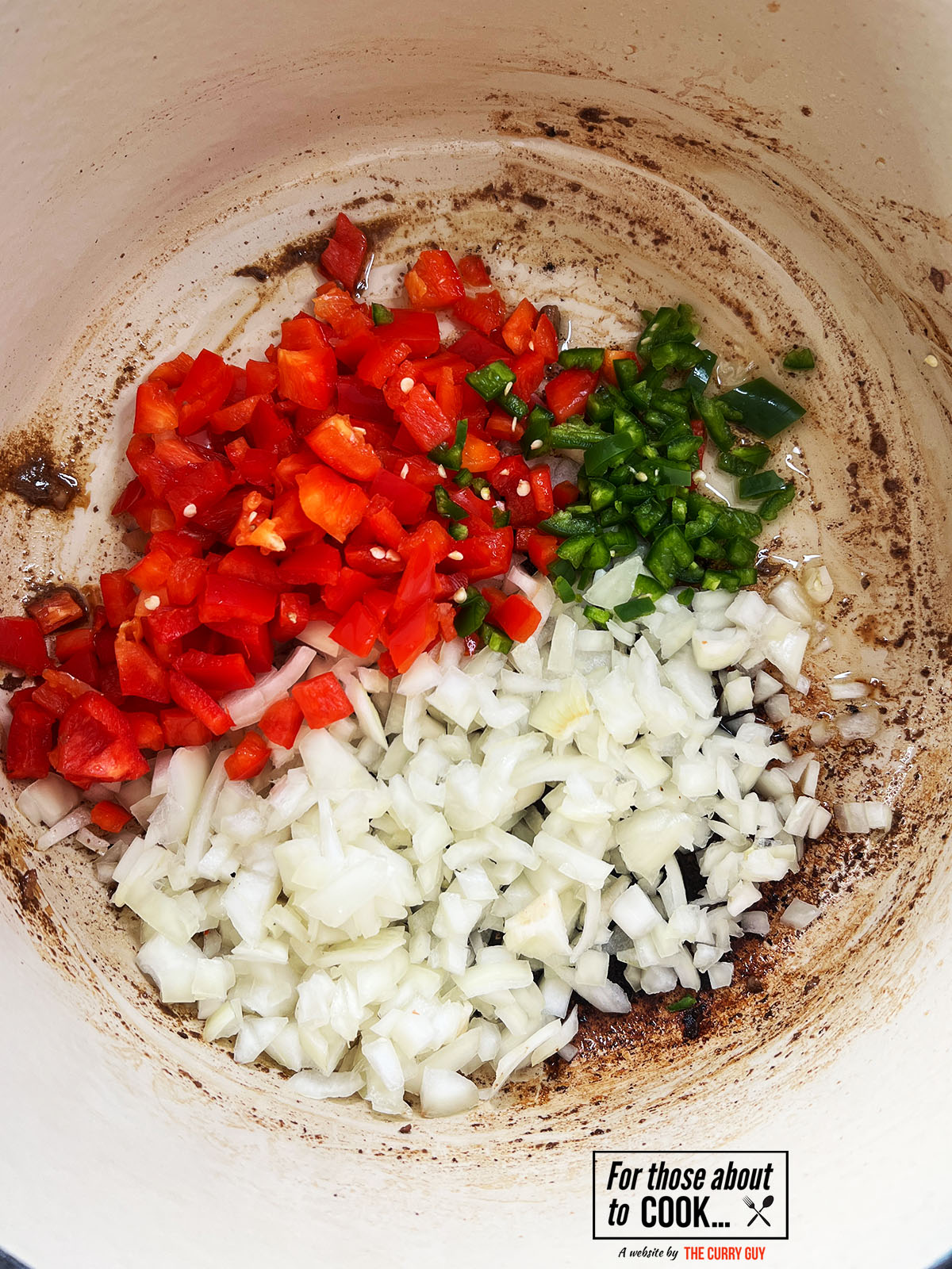 vegetables for the carne guisada frying in a pan