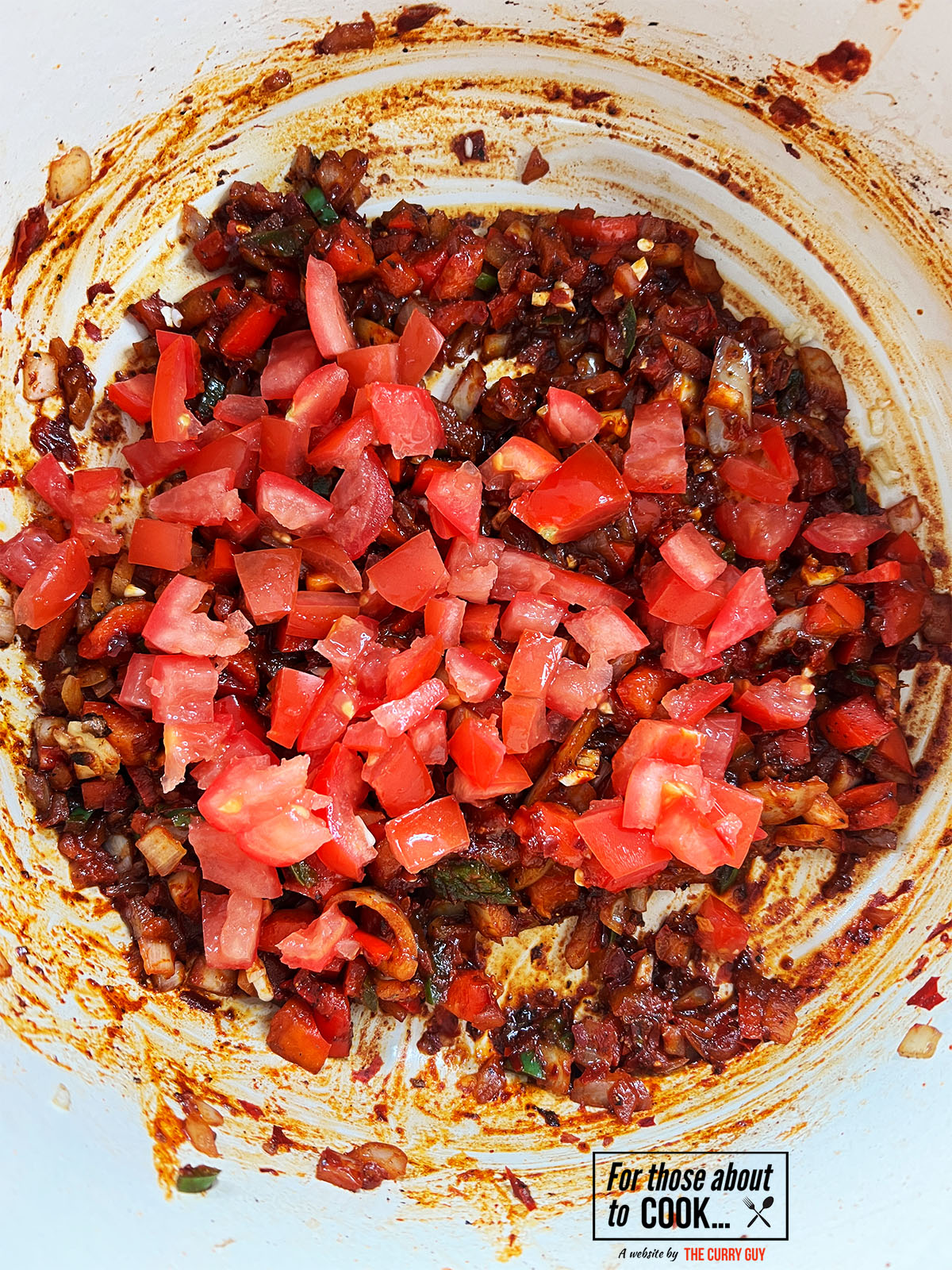 Diced tomatoes added to the pan