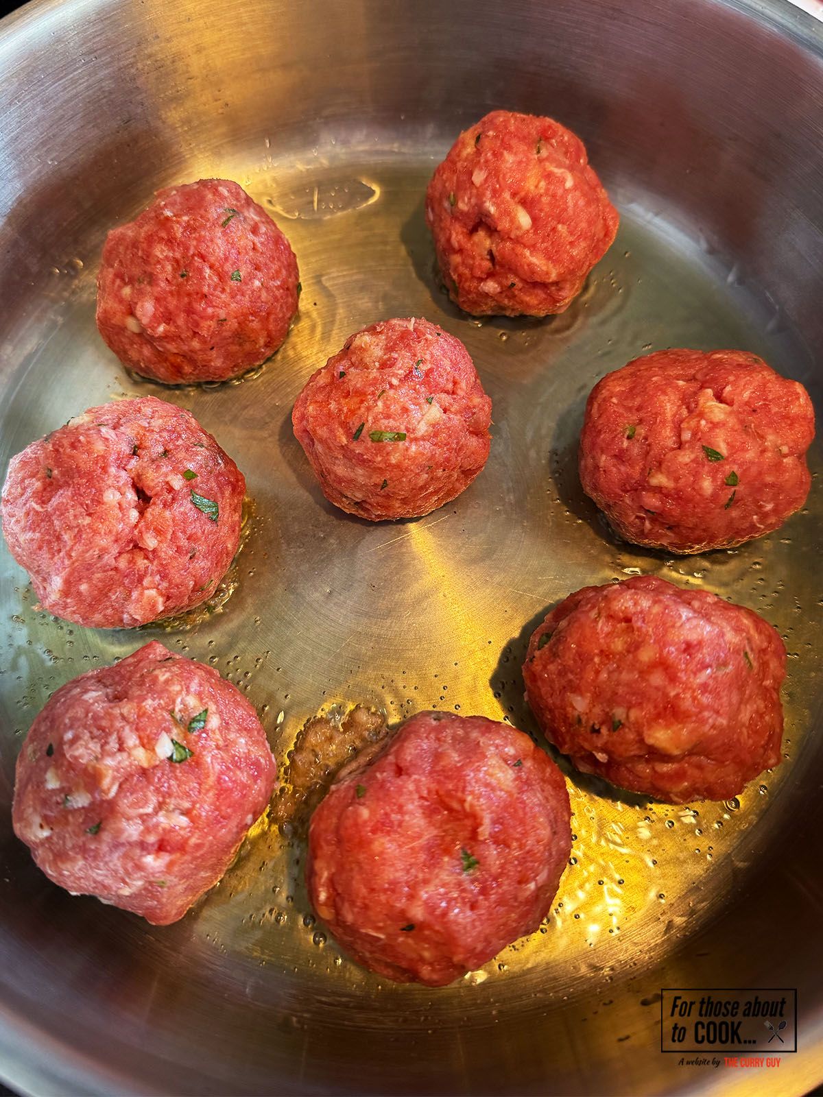 Meatballs frying in a pan 