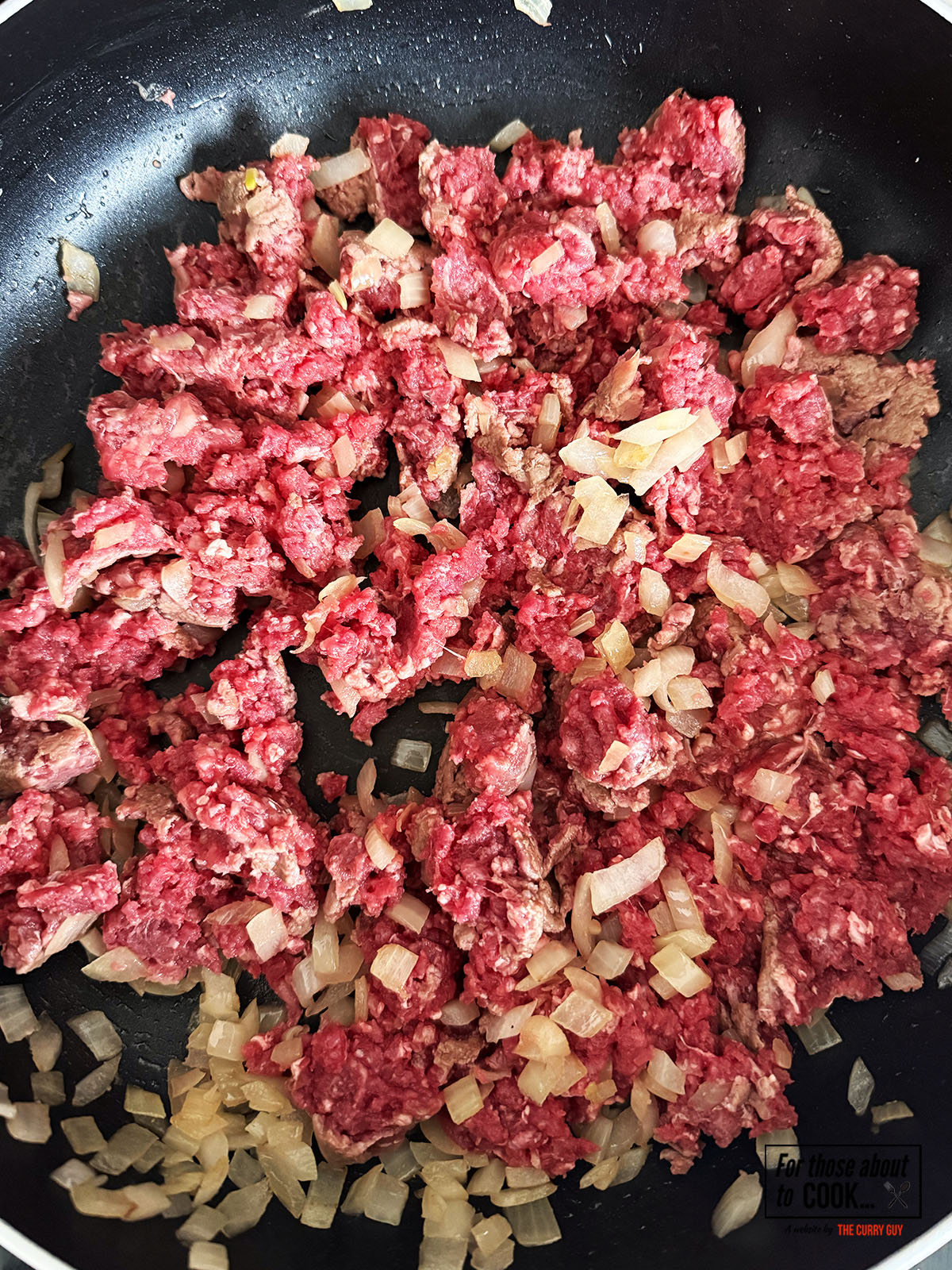 Beef frying with the onions in the pan