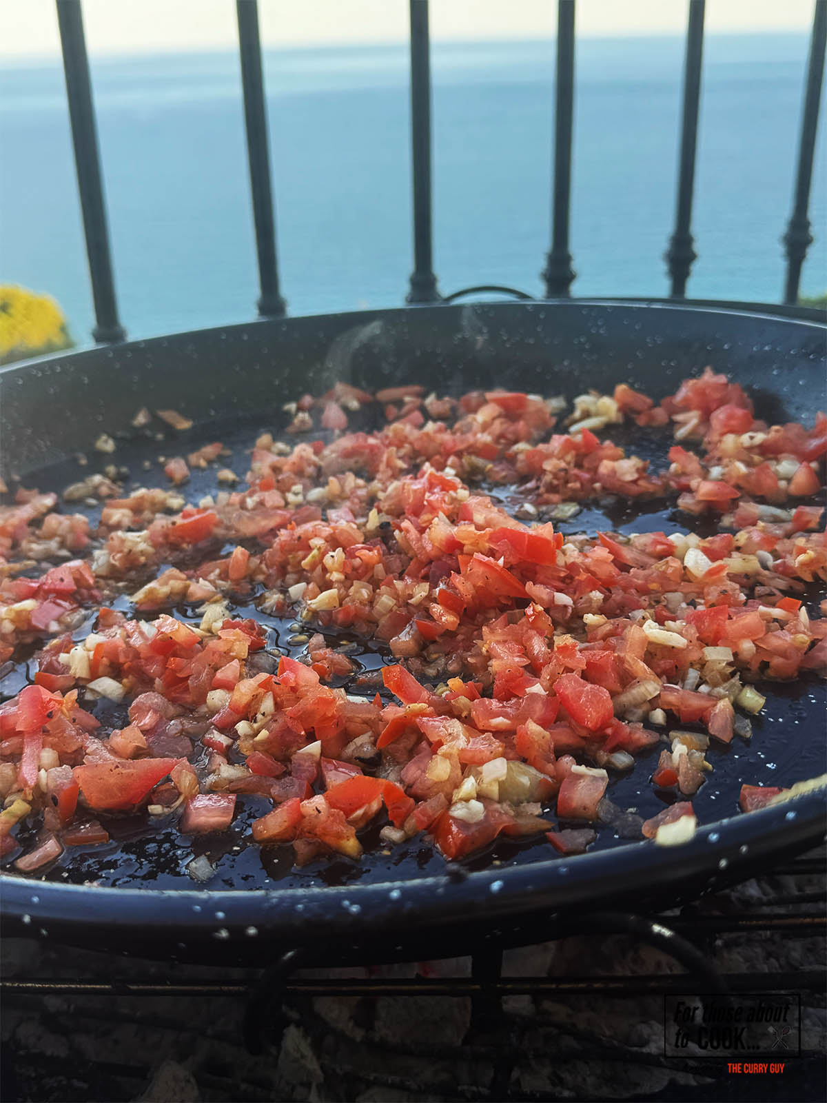 Adding the chopped tomatoes to the pan.