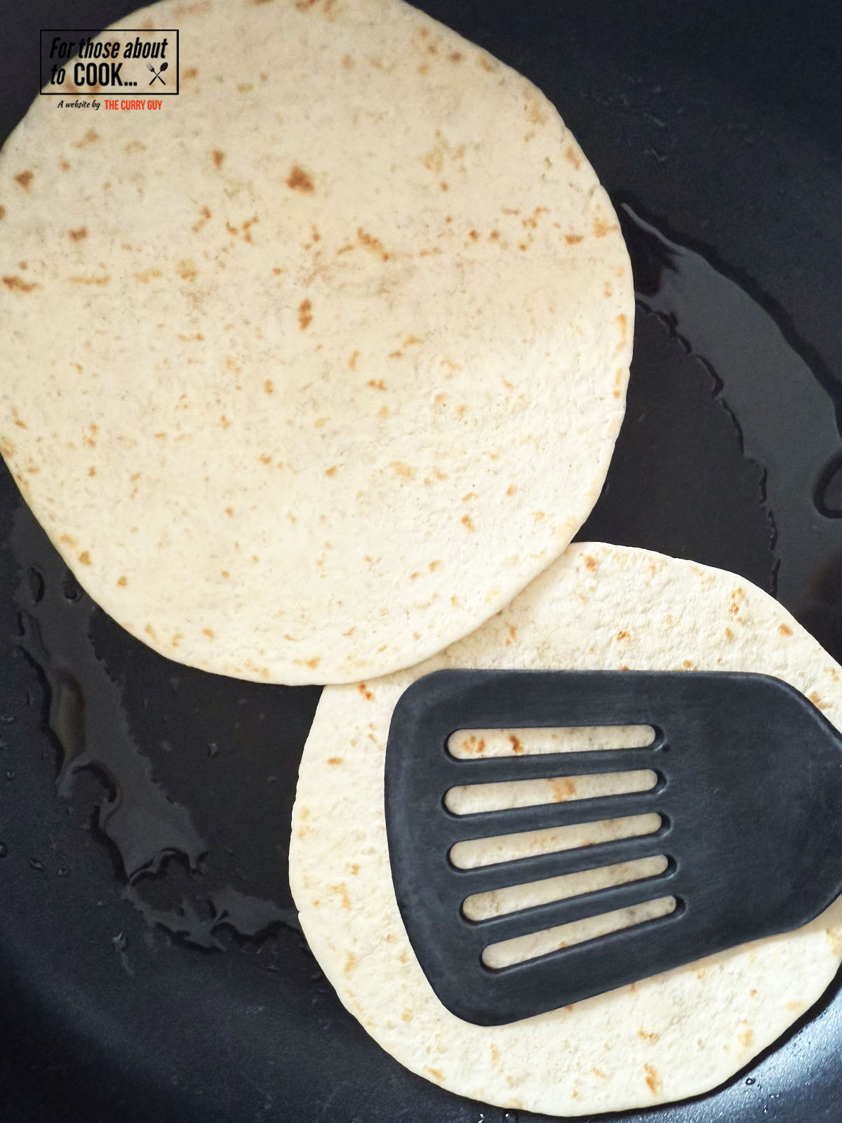 Smash burger tacos frying beef side down in a pan