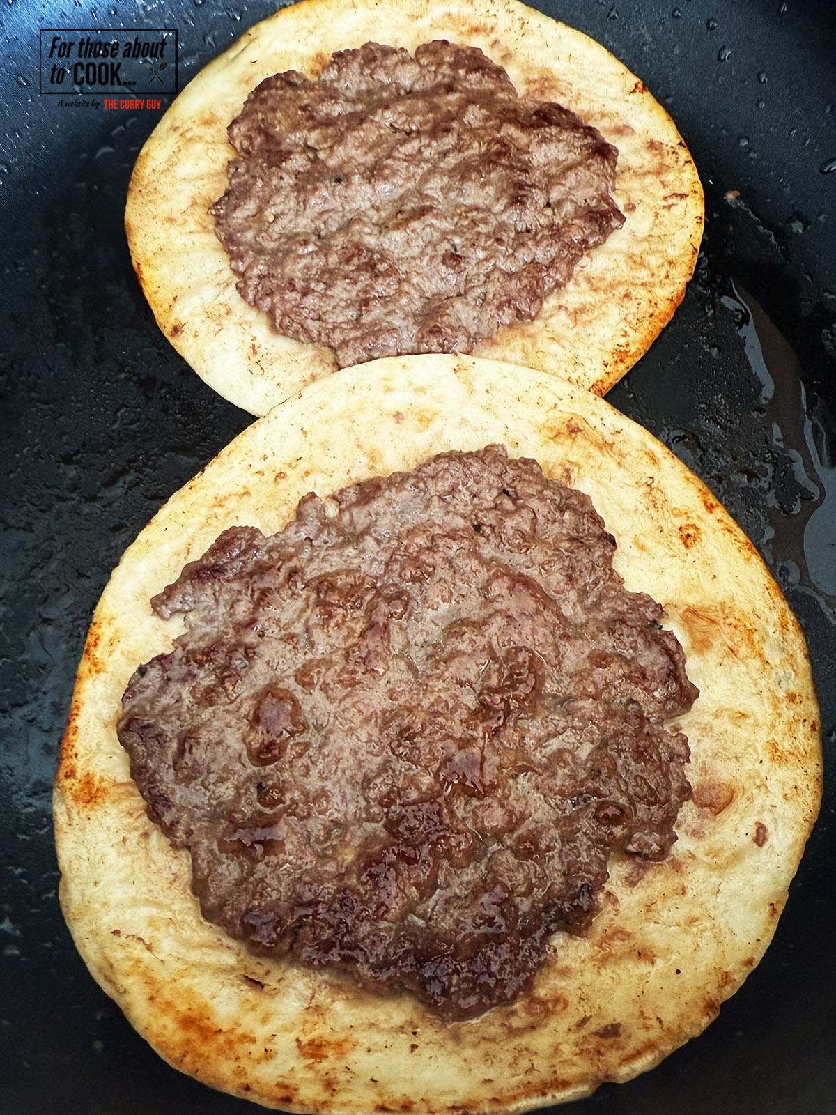 Smash burger tacos browned and flipped in a pan