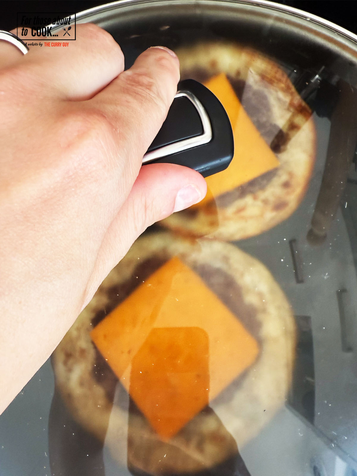 Lid covering cheese to allow melting