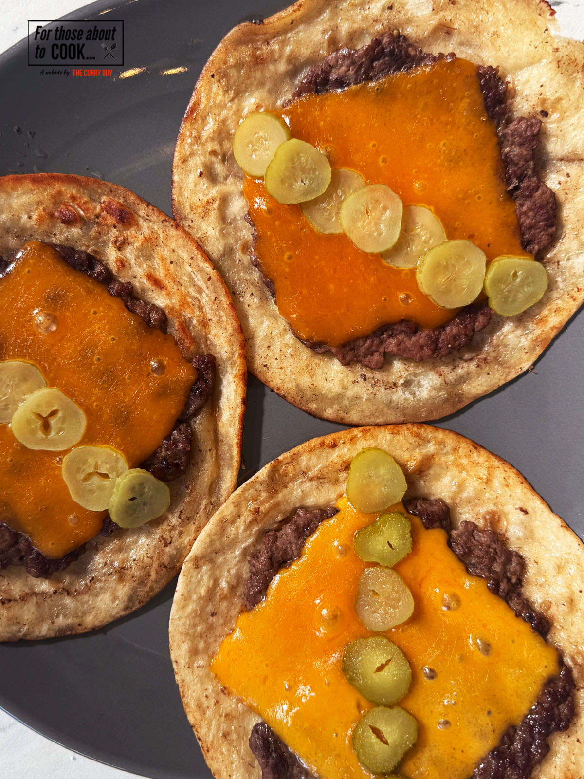 Smash burger tacos topped with pickles