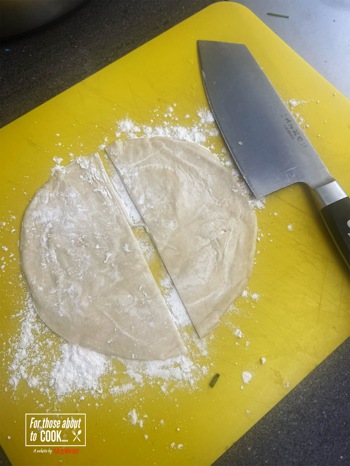 Slicing a frozen paratha in half and dusting it with flour.